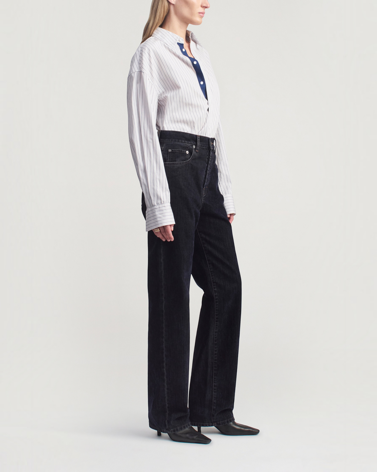 Weldun KALLMEYER Dani button down shirt in navy stripe cotton poplin worn by a model with dark wide leg jeans