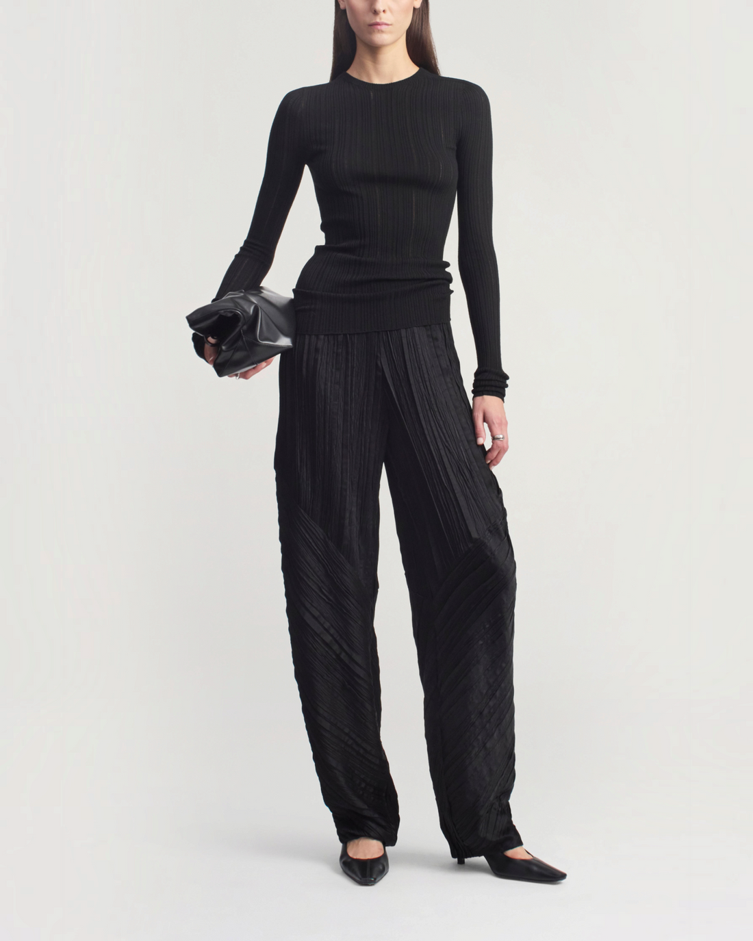Weldun KALLMEYER black fitted long sleeve top in superfine pointelle knit with round neckline and gathered sleeves.
