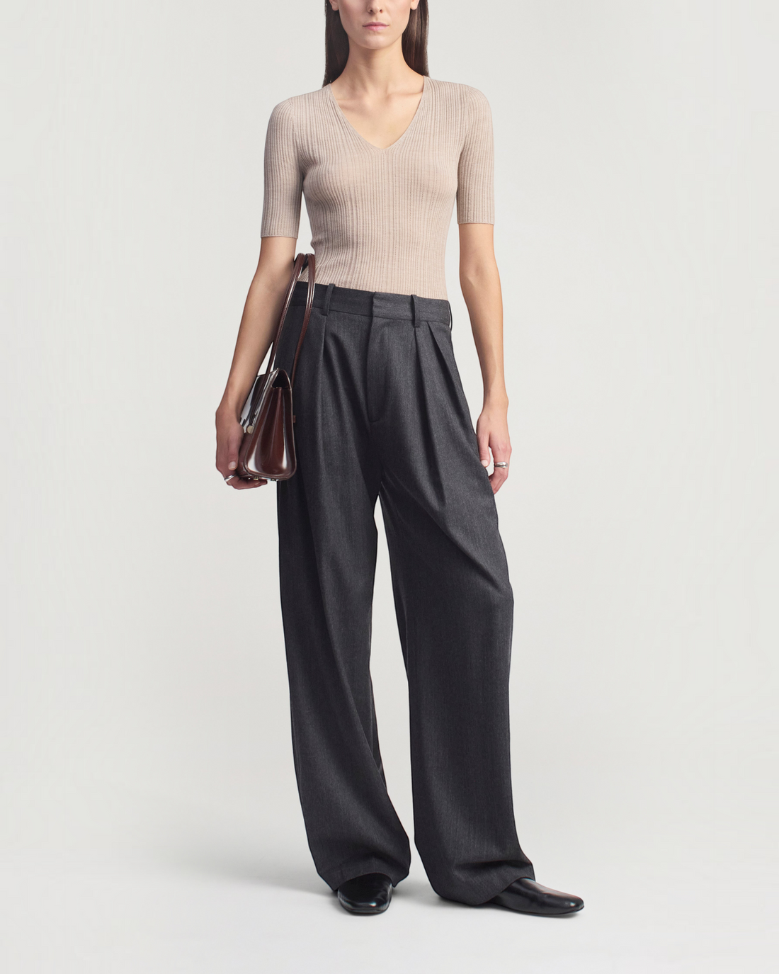 Weldun KALLMEYER Pika beige superfine pointelle V-neck knit top with elbow-length sleeves worn with charcoal trousers.