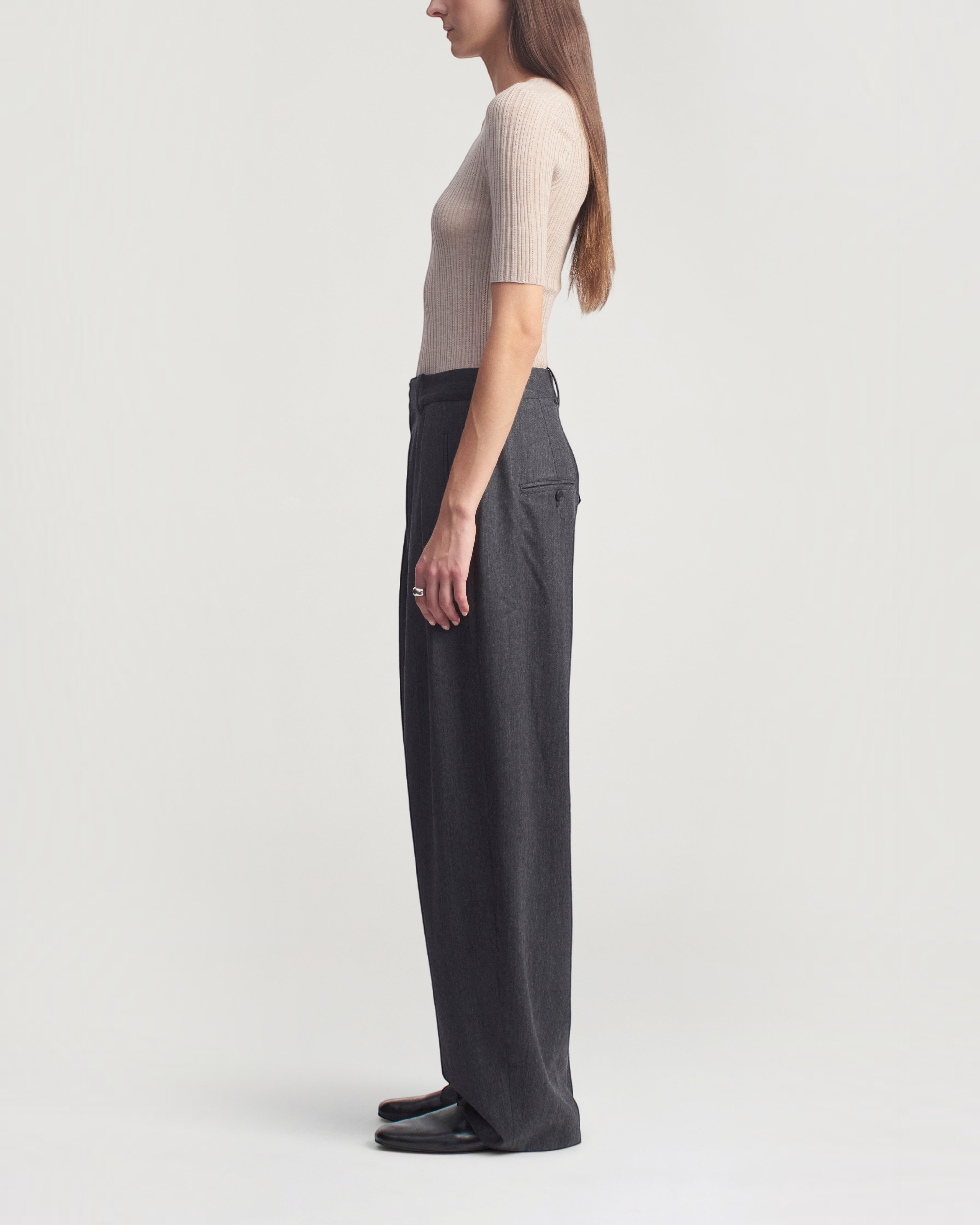 Weldun KALLMEYER Pika short sleeve V-neck top in beige superfine pointelle knit worn with charcoal trousers