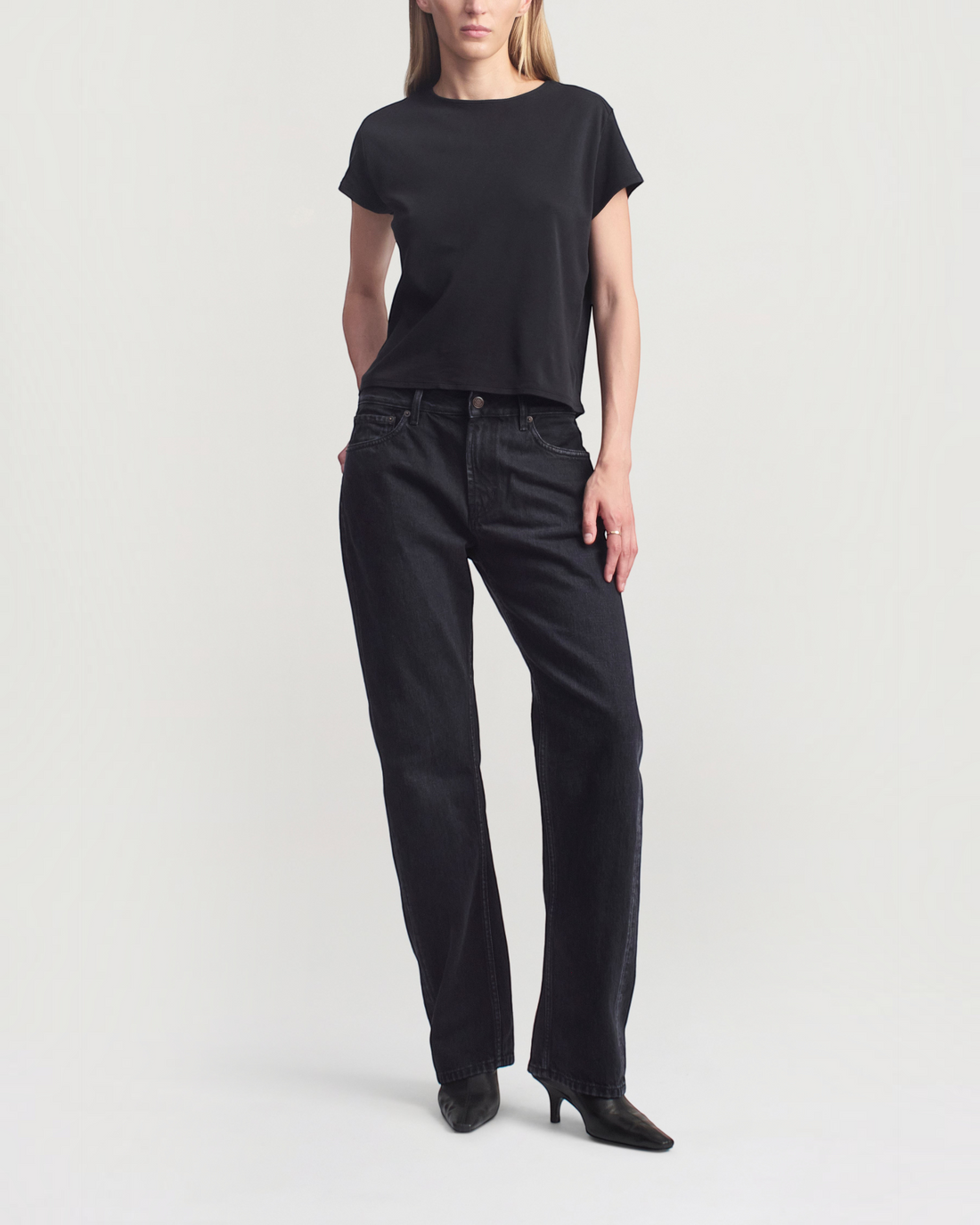 Weldun Willa Baby Tee in black cotton with a boxy fit, crewneck, and cap sleeves worn by a model.