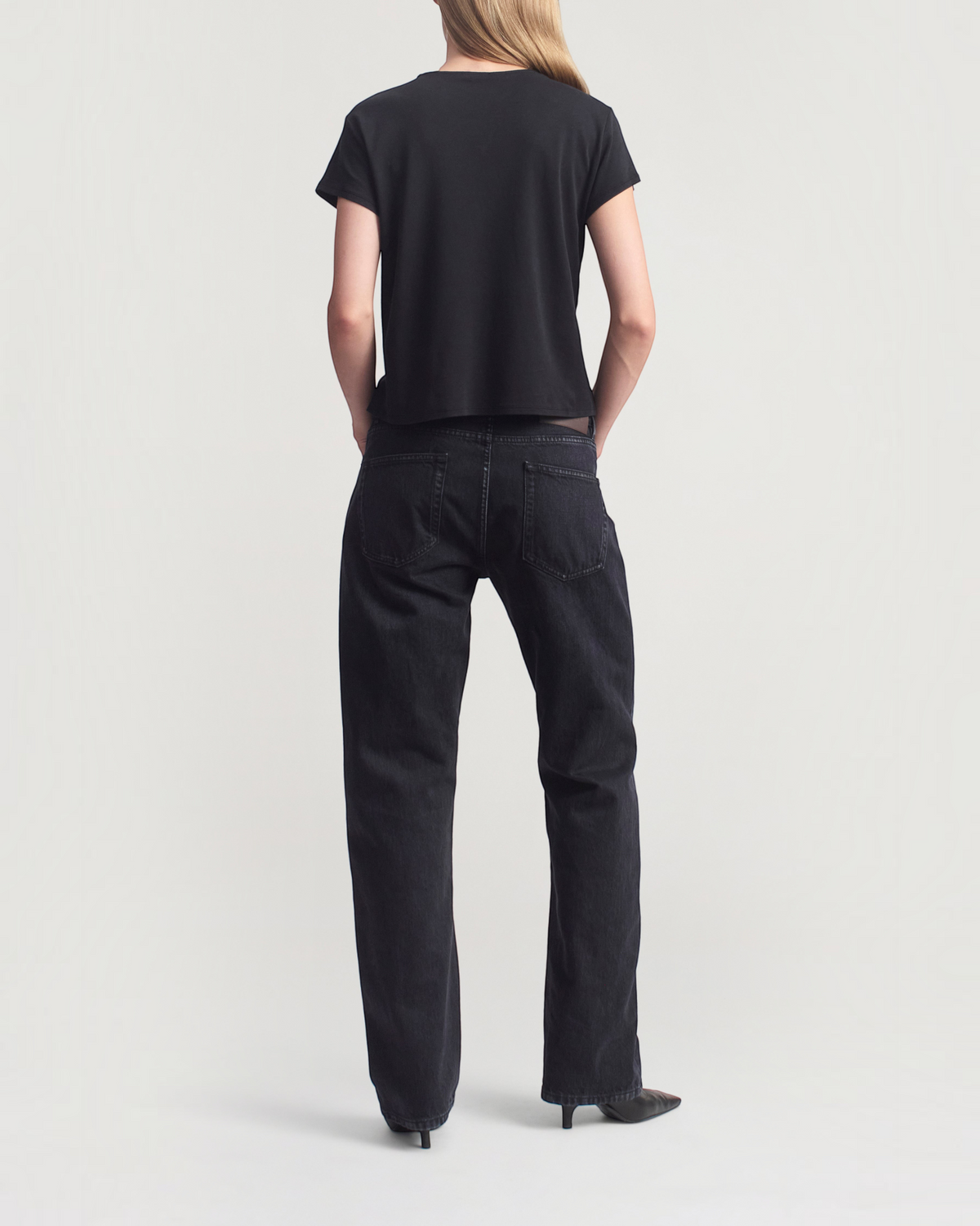 Weldun Willa Baby Tee in black cotton with a boxy fit, short cap sleeves, and crewneck, shown from the back.