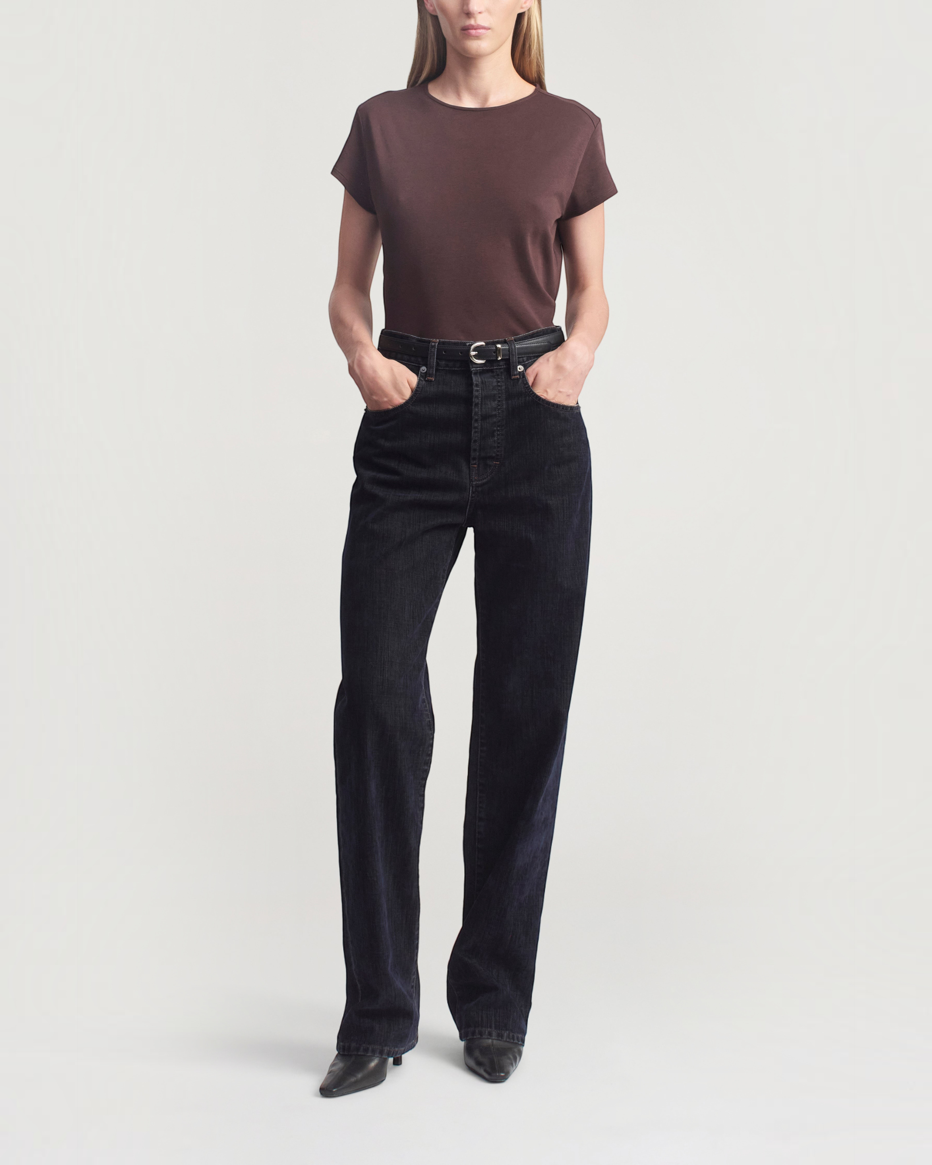 Weldun KALLMEYER Willa Baby Tee in cacao brown cotton with a crewneck and cap sleeves worn with dark denim jeans.