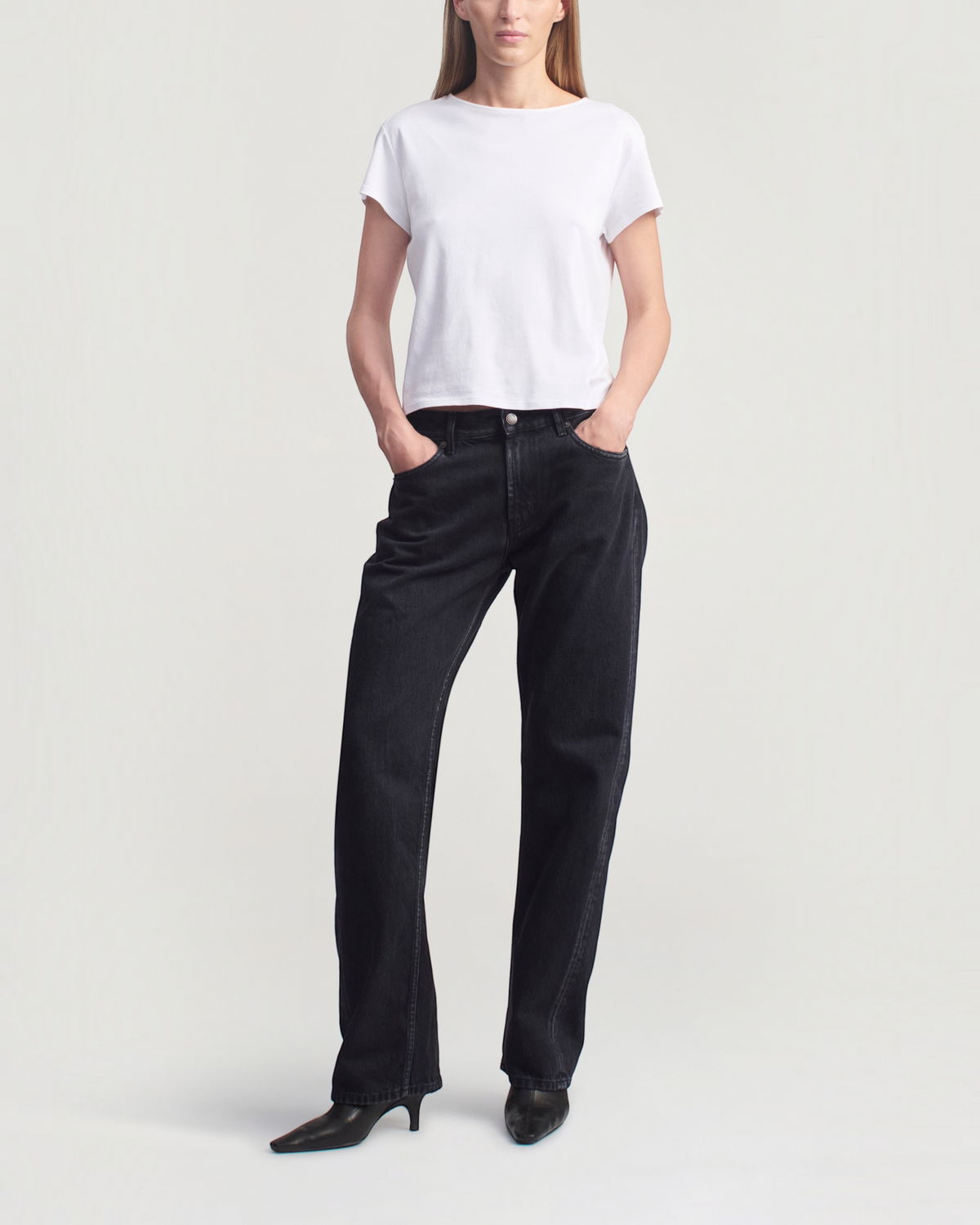 Weldun Willa Baby Tee in white cotton with cap sleeves and a boxy fit worn by a model with black jeans