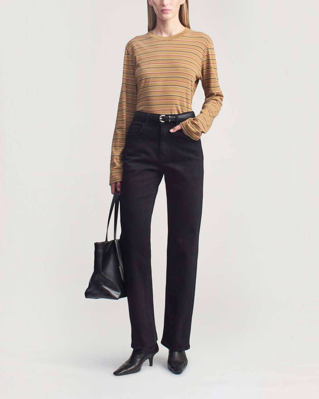 Weldun Wynn long sleeve t-shirt in camel stripe with a relaxed boxy fit, worn with black trousers and a tote bag.
