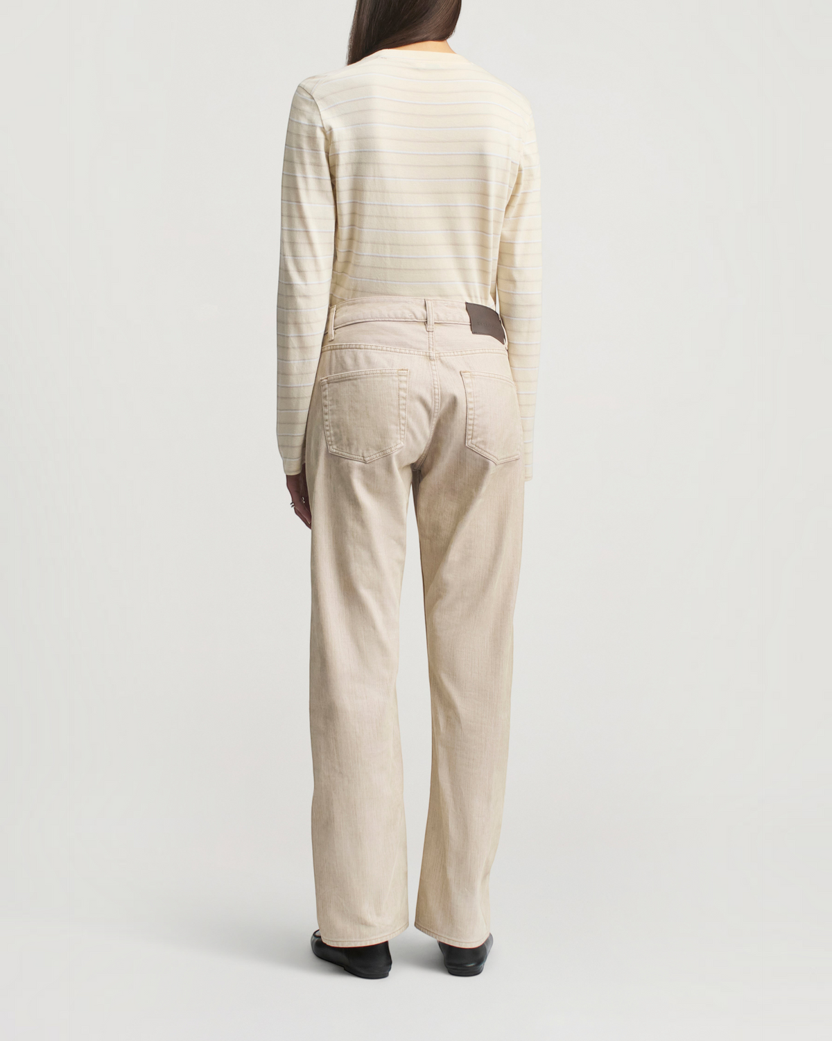 Weldun KALLMEYER Wynn long sleeve t-shirt in ecru stripe with a relaxed fit worn with beige trousers, back view.
