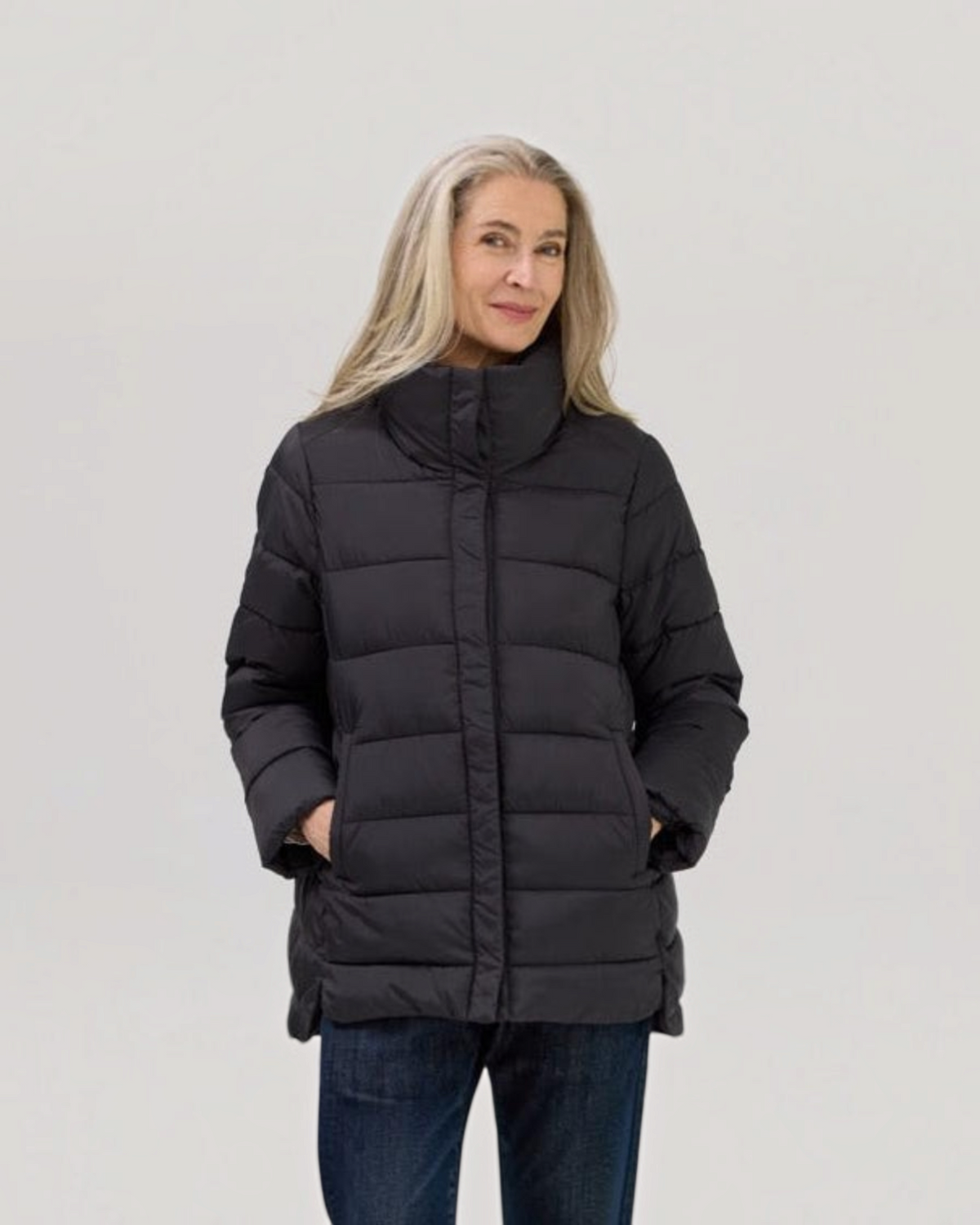 Weldun Weatherproof x MagnaReady black magnetic puffer jacket worn by a woman with long grey hair