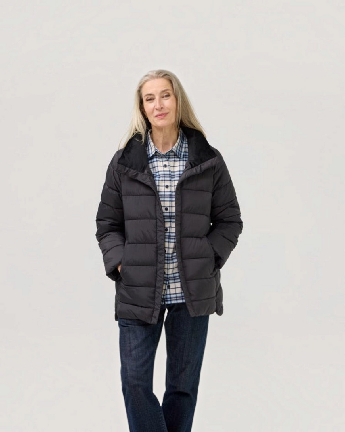 Weldun Weatherproof x MagnaReady black magnetic puffer jacket worn by a woman with long grey hair.