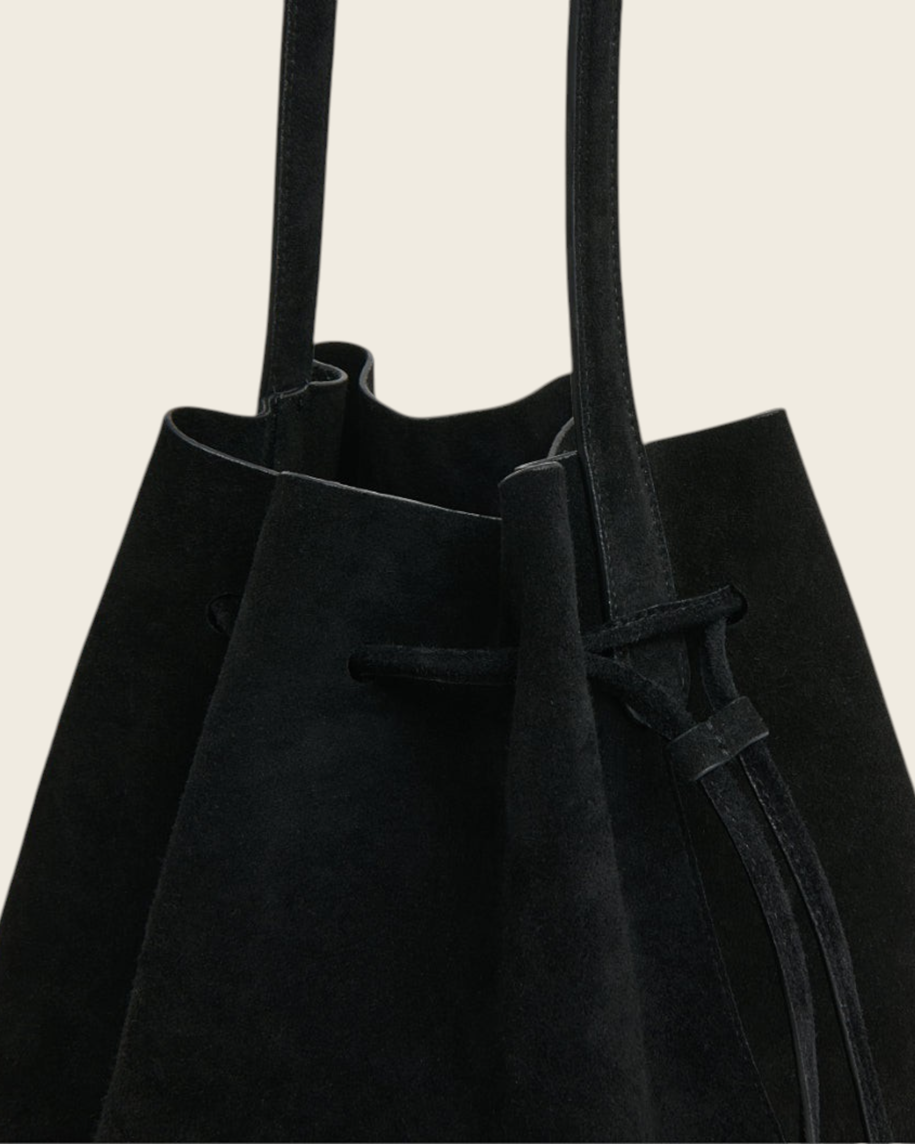 Weldun black suede drawstring bucket bag with long shoulder straps and slouchy silhouette