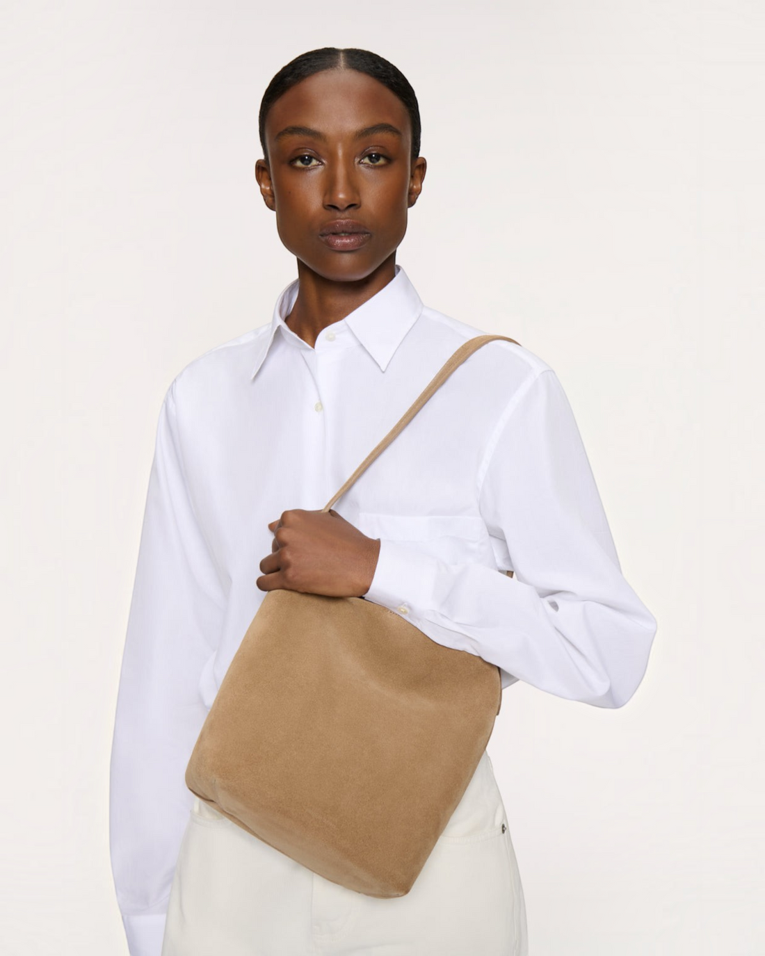 Weldun Mansur Gavriel Small Everyday Cabas in anise suede carried over the shoulder by a model in a white shirt