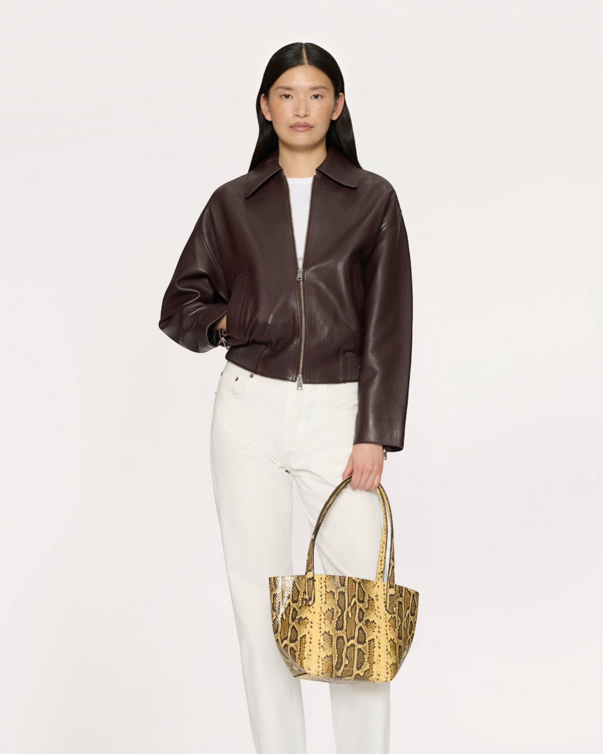 Weldun model carrying a Mansur Gavriel small everyday soft tote in golden roccia printed Italian goat leather