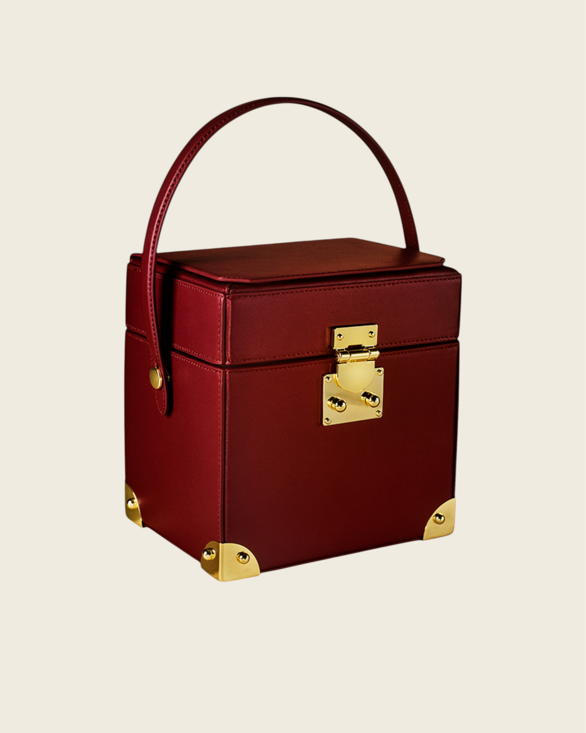 Weldun Themis breastmilk cooler in deep red nappa leather with gold hardware and a structured top handle design.