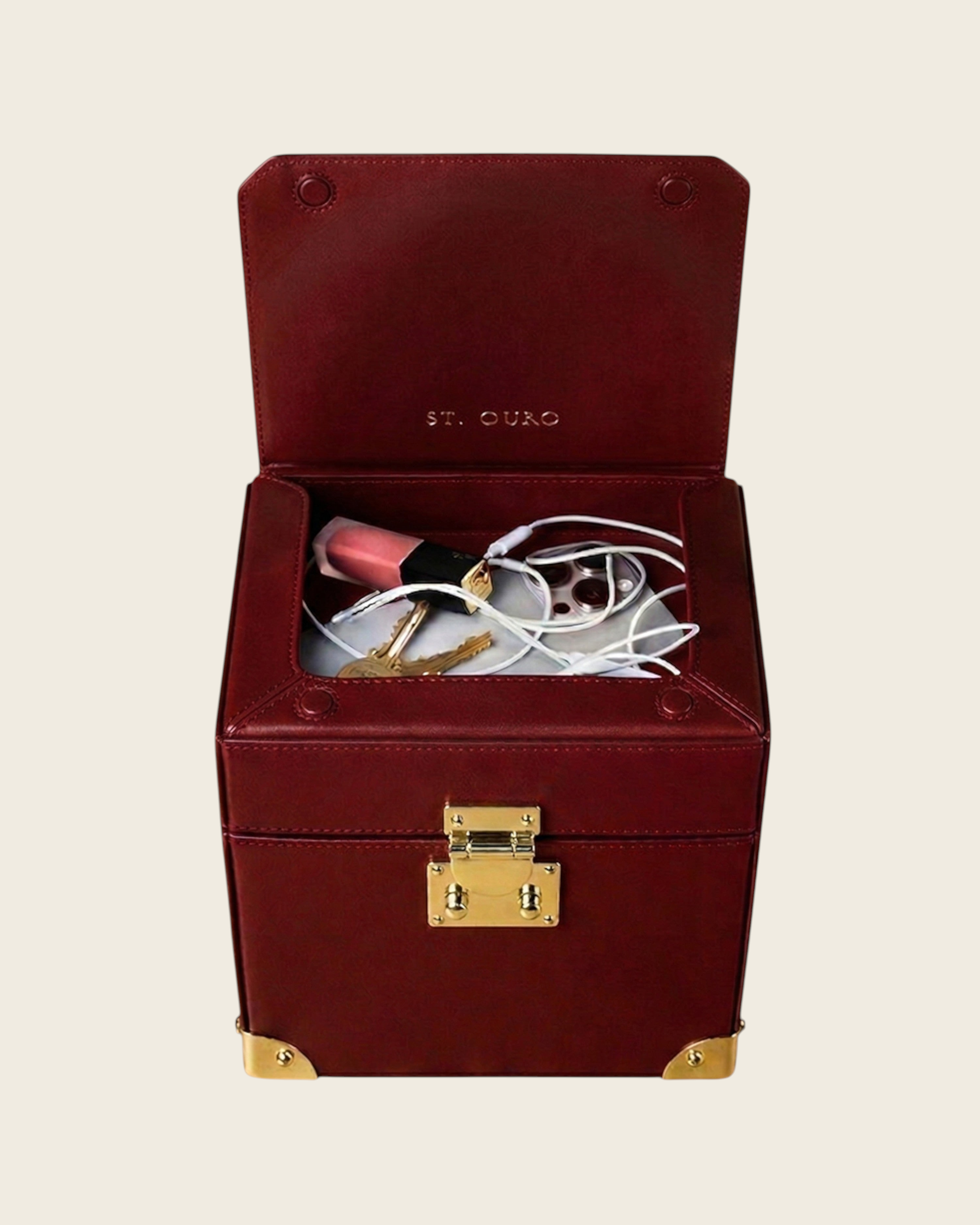 Weldun Themis breastmilk cooler in deep red nappa leather with gold hardware and open top compartment for essentials.