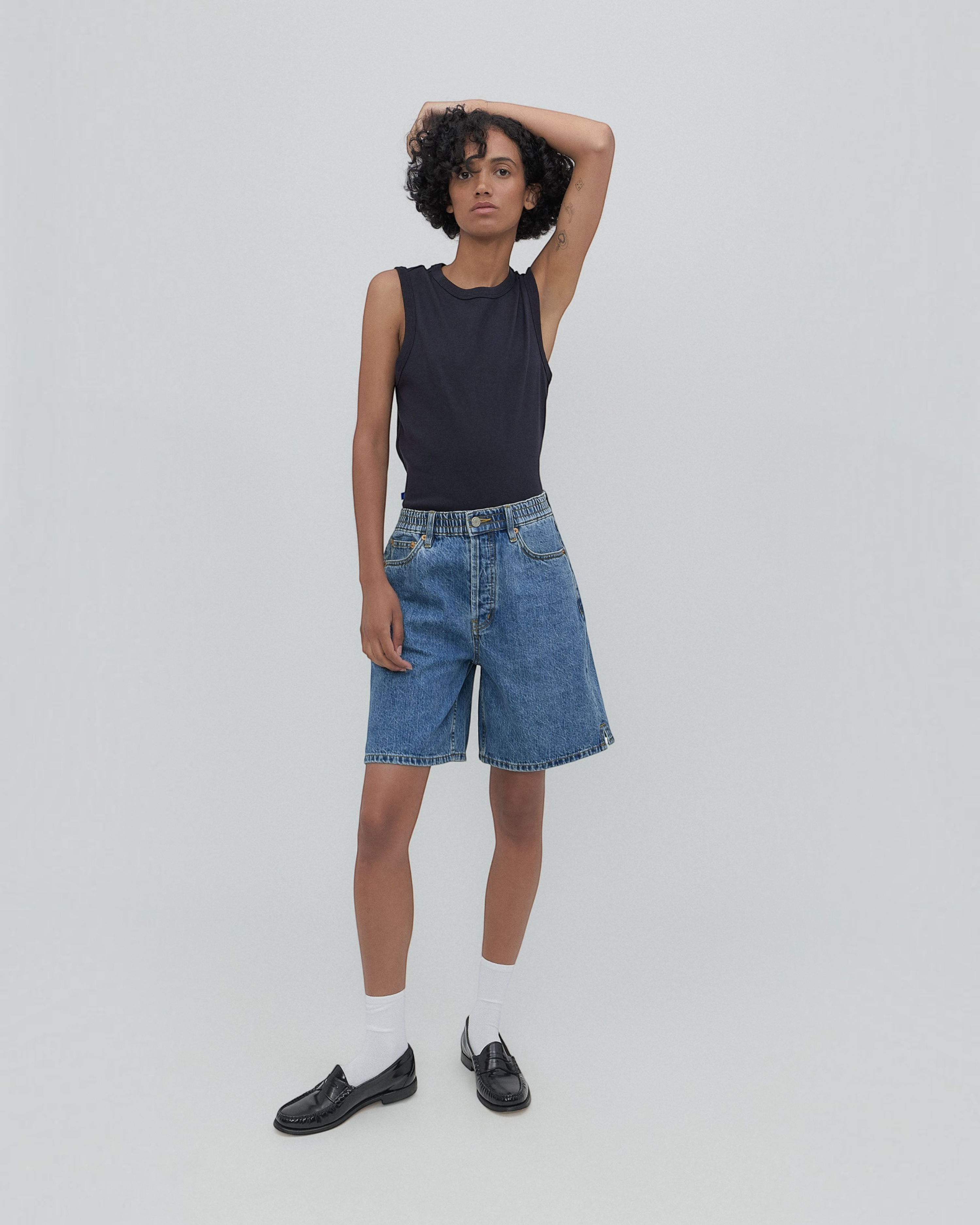 Weldun Lola high-waisted denim shorts in classic blue with a scrunch waistband and side-seam hem detail on a model.