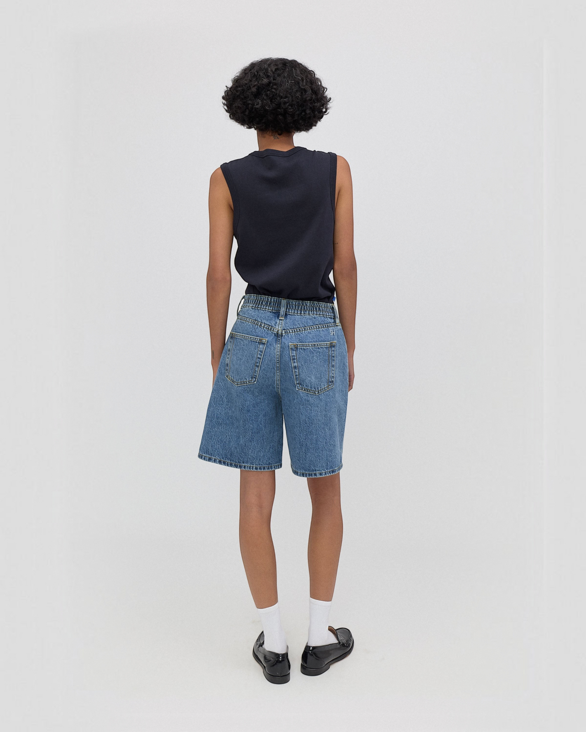 Weldun Still Here Lola high-waisted wide leg denim shorts in classic blue with elastic waistband, back view.