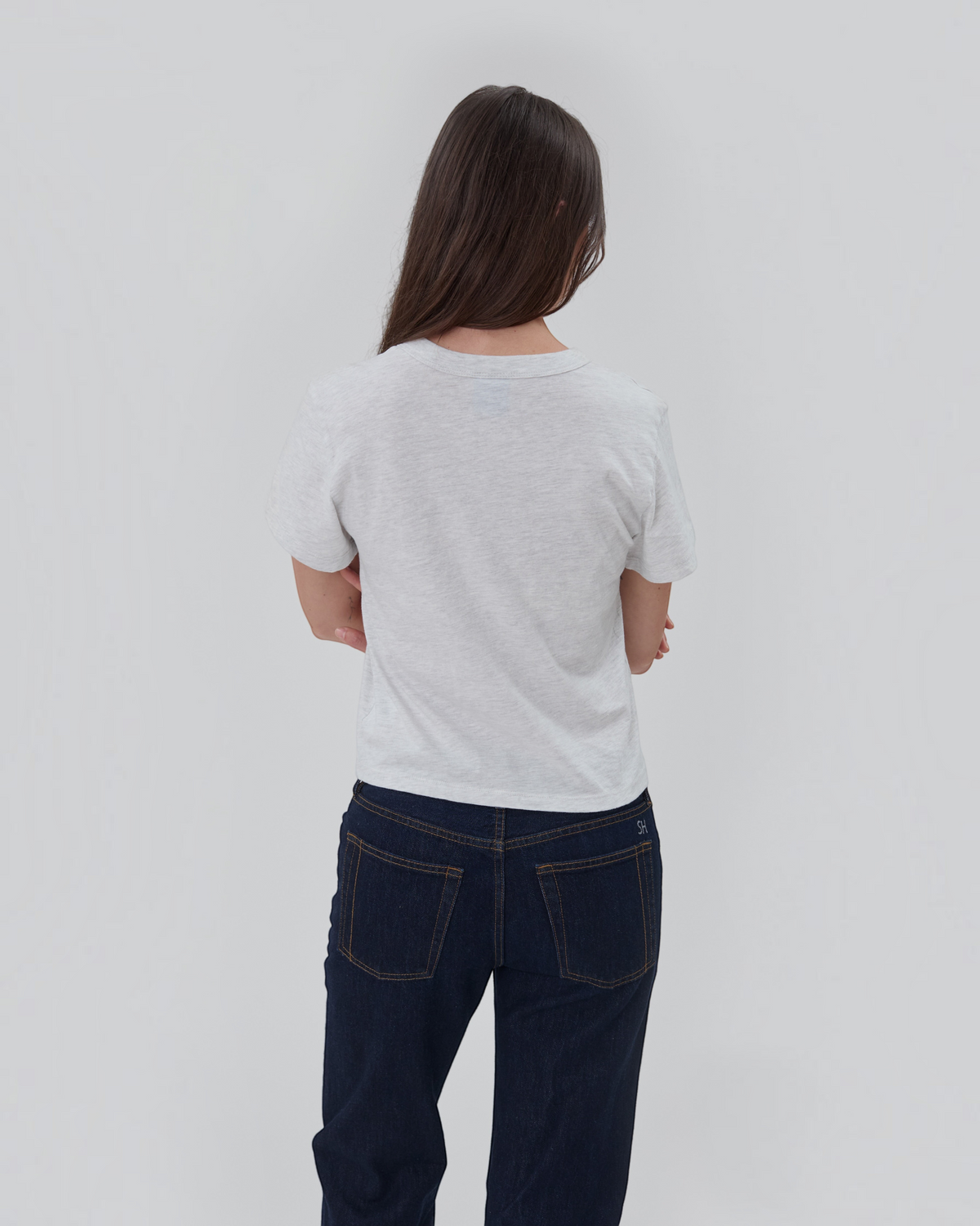 Weldun Still Here grey short sleeve cotton Henley shirt worn by a woman from the back view