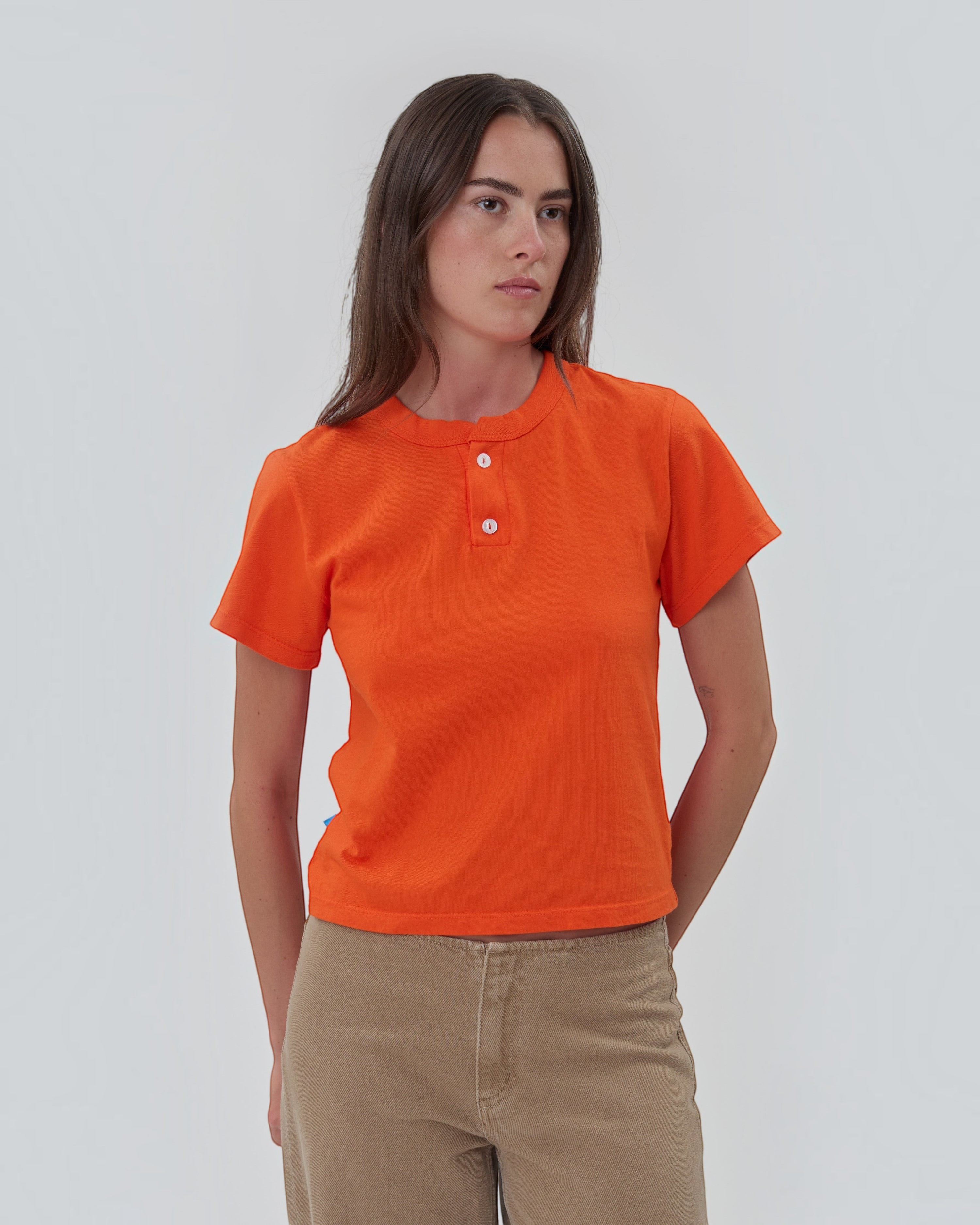 Weldun Still Here orange cotton short sleeve Henley shirt with two-button placket worn by a model