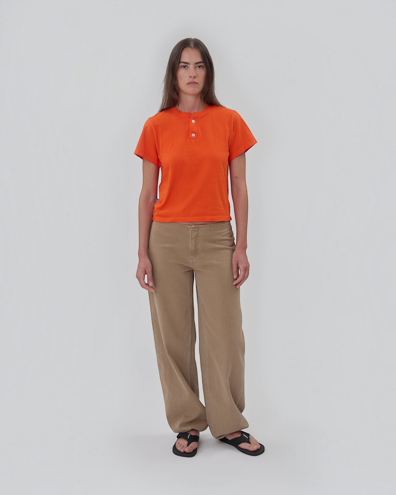Weldun Still Here orange cotton short sleeve Henley shirt with two-button placket worn by a model