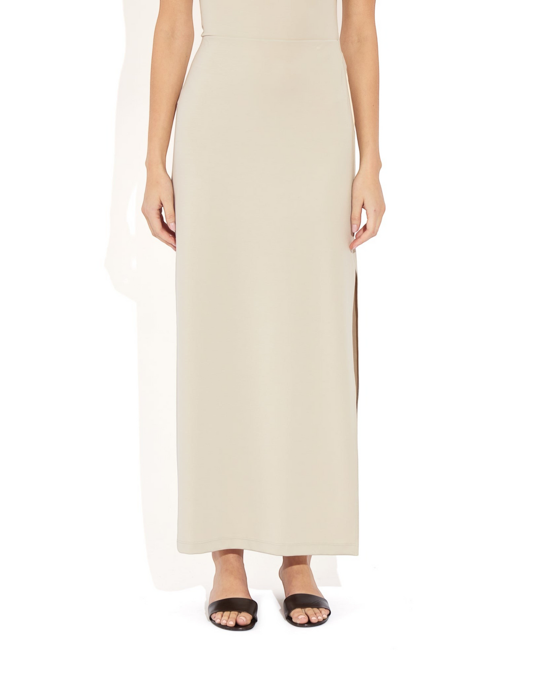Weldun Ashley Skirt in beige stretch PYRATEX fabric featuring a column silhouette and a side slit on a model