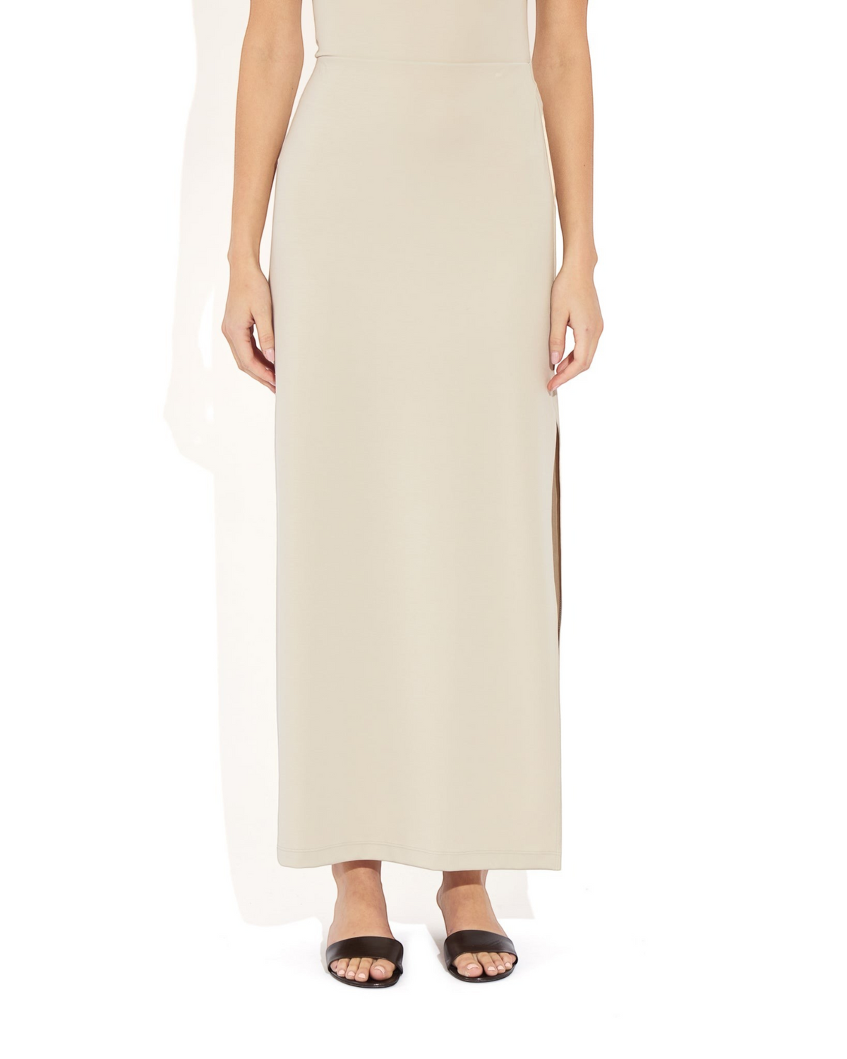 Weldun Ashley Skirt in beige stretch PYRATEX fabric featuring a column silhouette and a side slit on a model