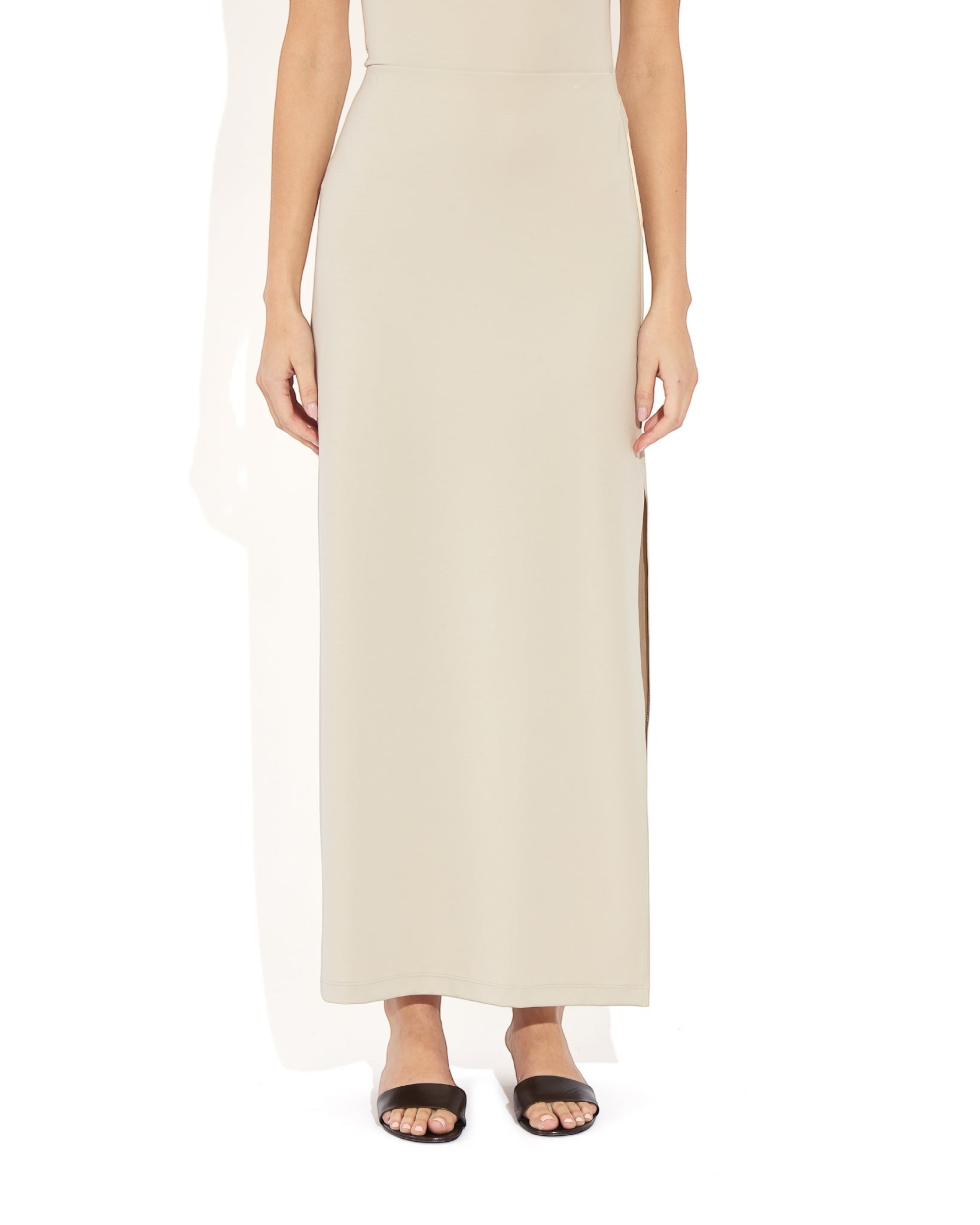 Weldun Ashley Skirt in beige stretch PYRATEX fabric featuring a column silhouette and a side slit on a model