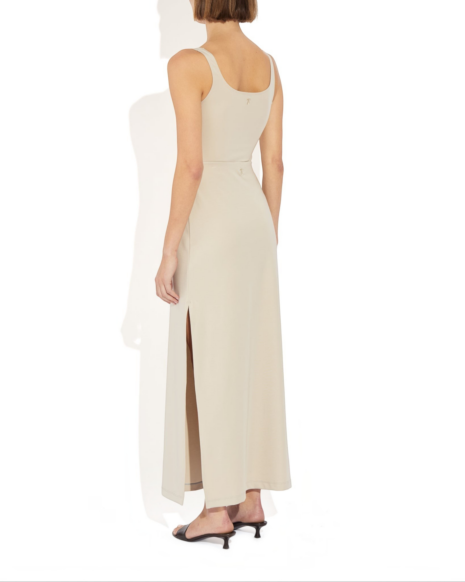 Weldun Ashley Skirt in beige featuring a fluid column silhouette, pull-on design, and a high side slit on the thigh.