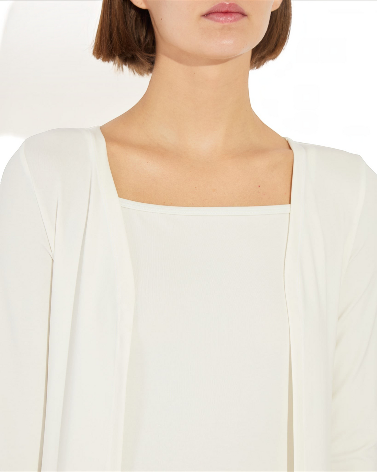 Weldun Julia Cardigan in white, featuring an open-front design made from soft, breathable PYRATEX Power 3 fabric.