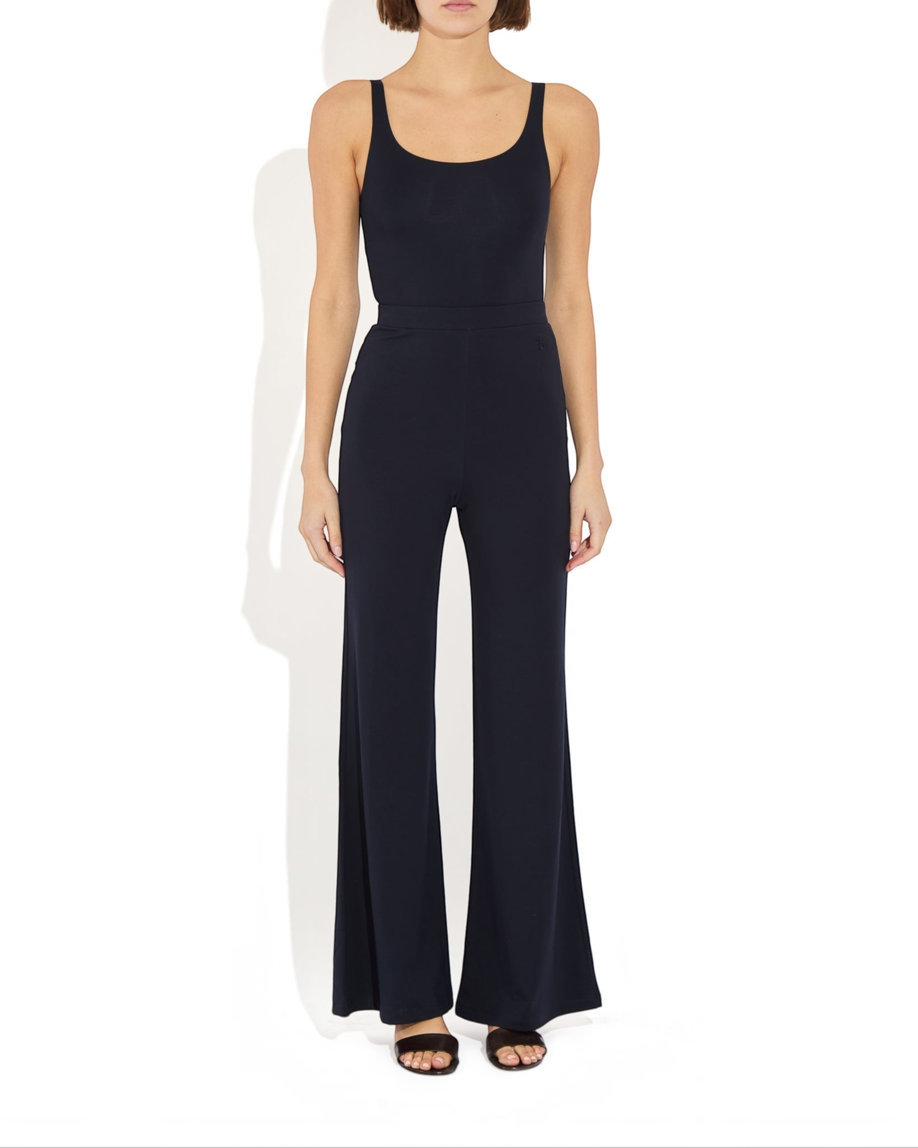 Weldun Lisa Bodysuit in black featuring a scoop neckline and supportive compressive fabric on a model