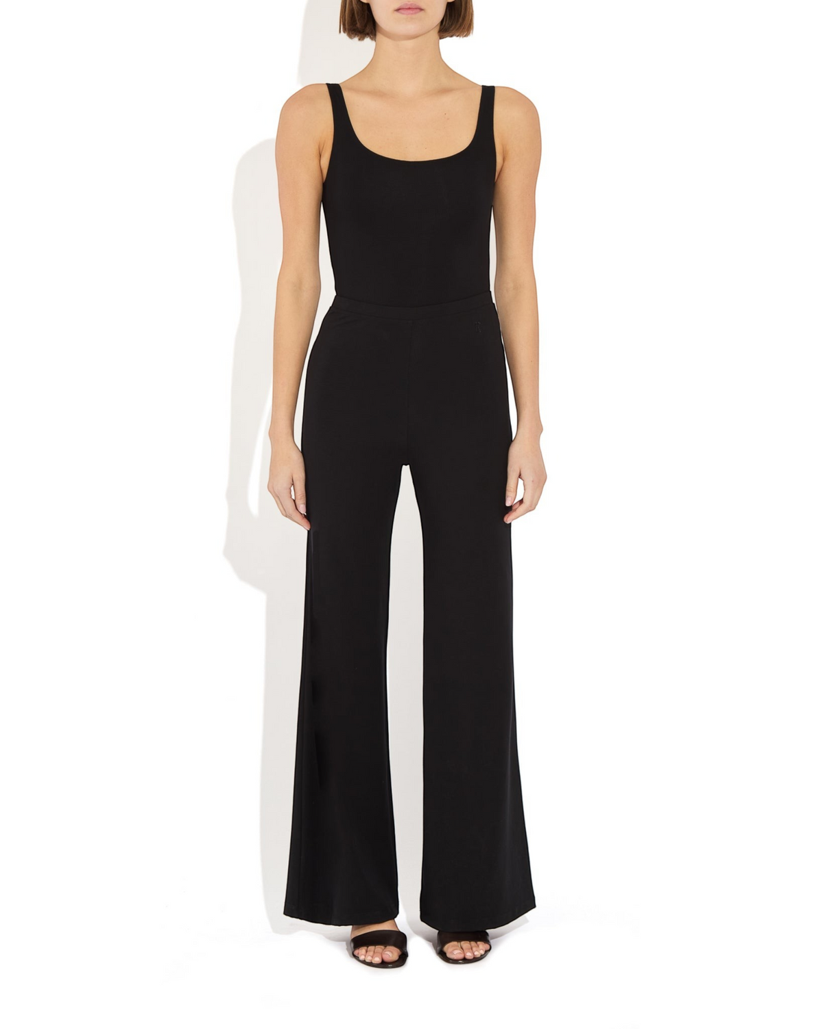 Weldun Lisa Bodysuit in black featuring a scoop neckline and supportive, breathable fabric on a model