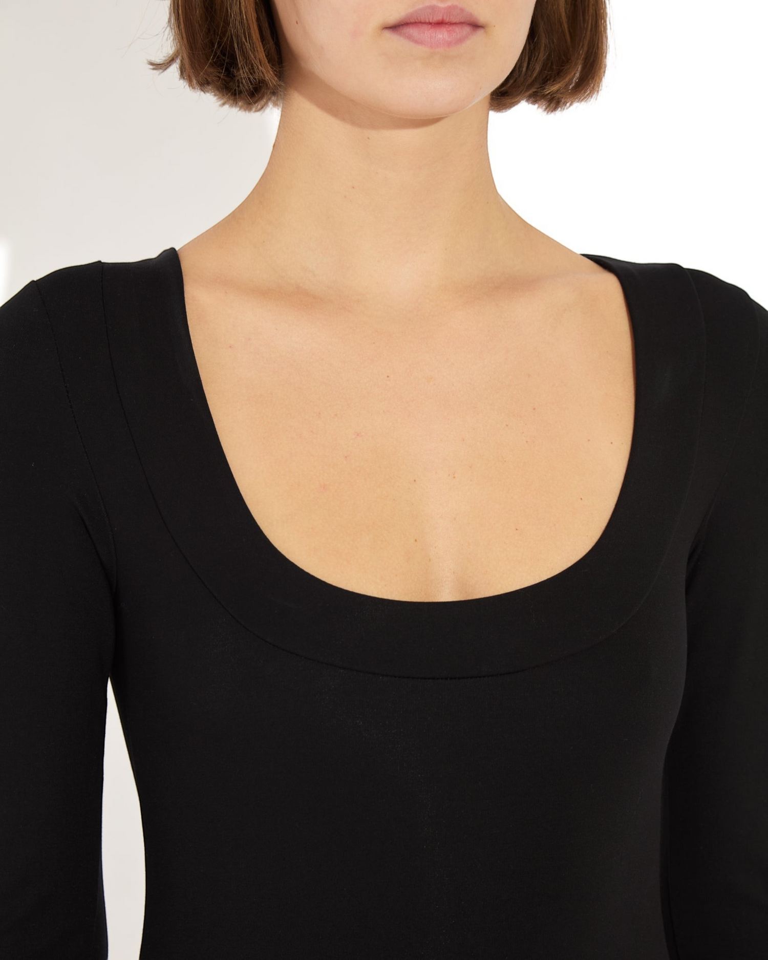 Weldun Maranda Bodysuit in black featuring a low scoop neckline with a structured wide band finish.
