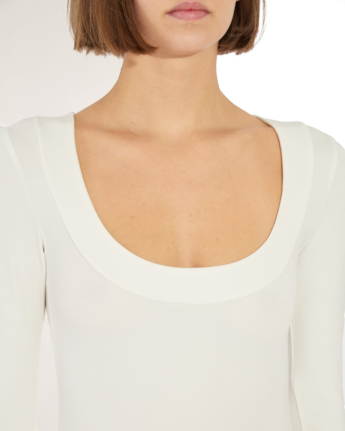 Weldun Maranda bodysuit in white featuring a low scoop neckline with a wide banded finish in stretch fabric