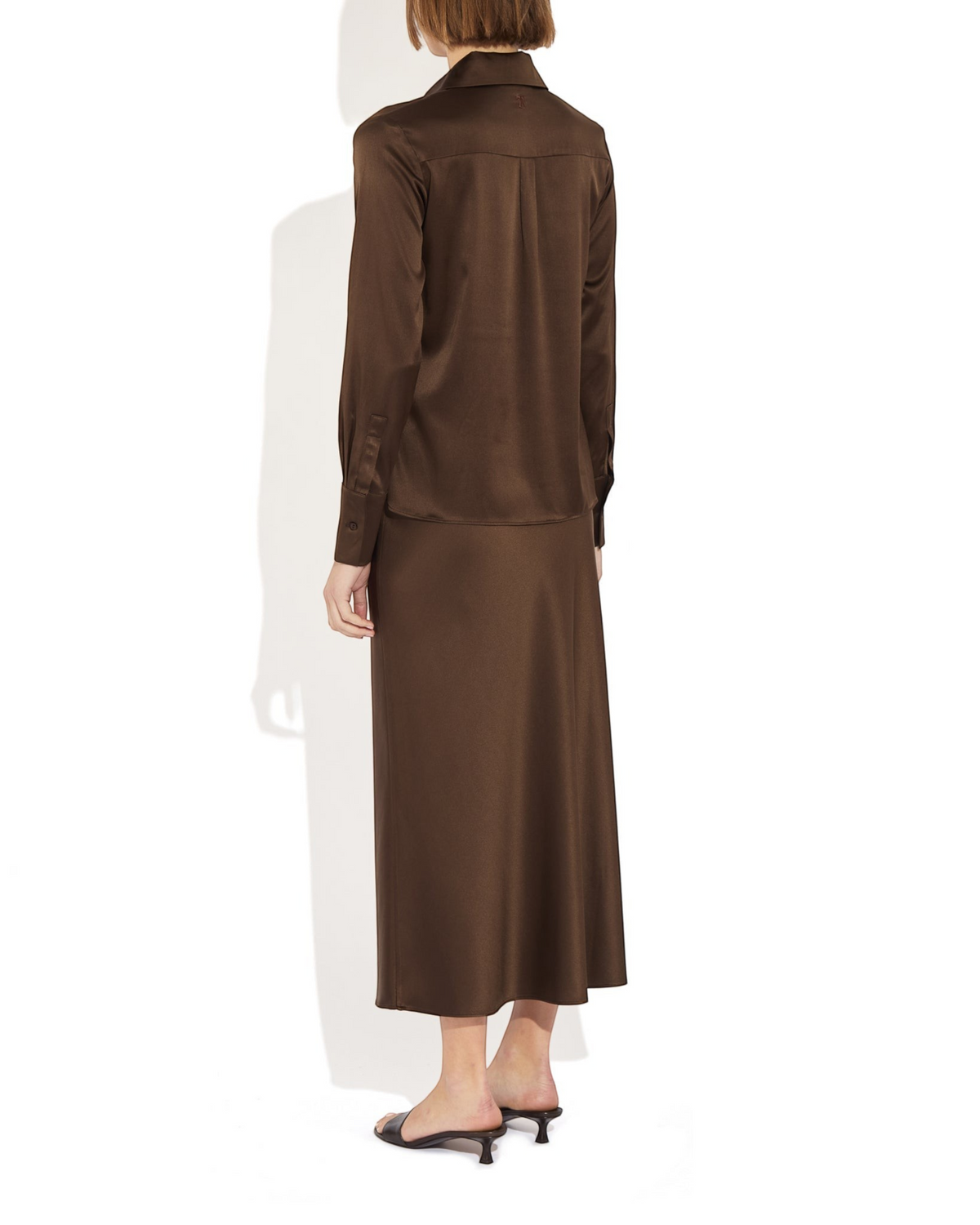 Weldun Max Skirt in dark brown stretch silk worn with a matching long-sleeve blouse, showing a fluid bias-cut drape.