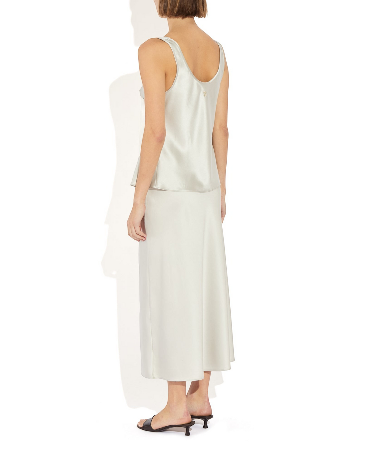 Weldun Max Skirt in light grey stretch silk with an elastic waistband, shown from the back on a model
