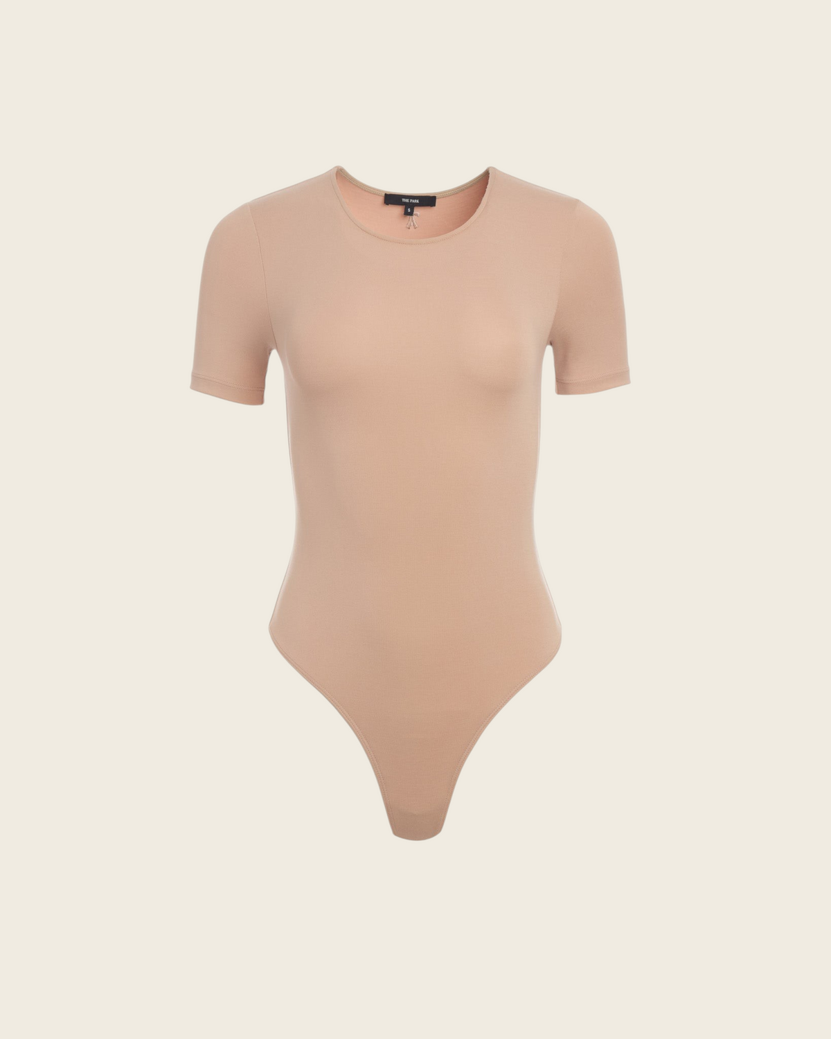 Weldun Penny short-sleeve bodysuit in beige MicroTencel fabric featuring a crew neckline and cheeky bottom coverage.