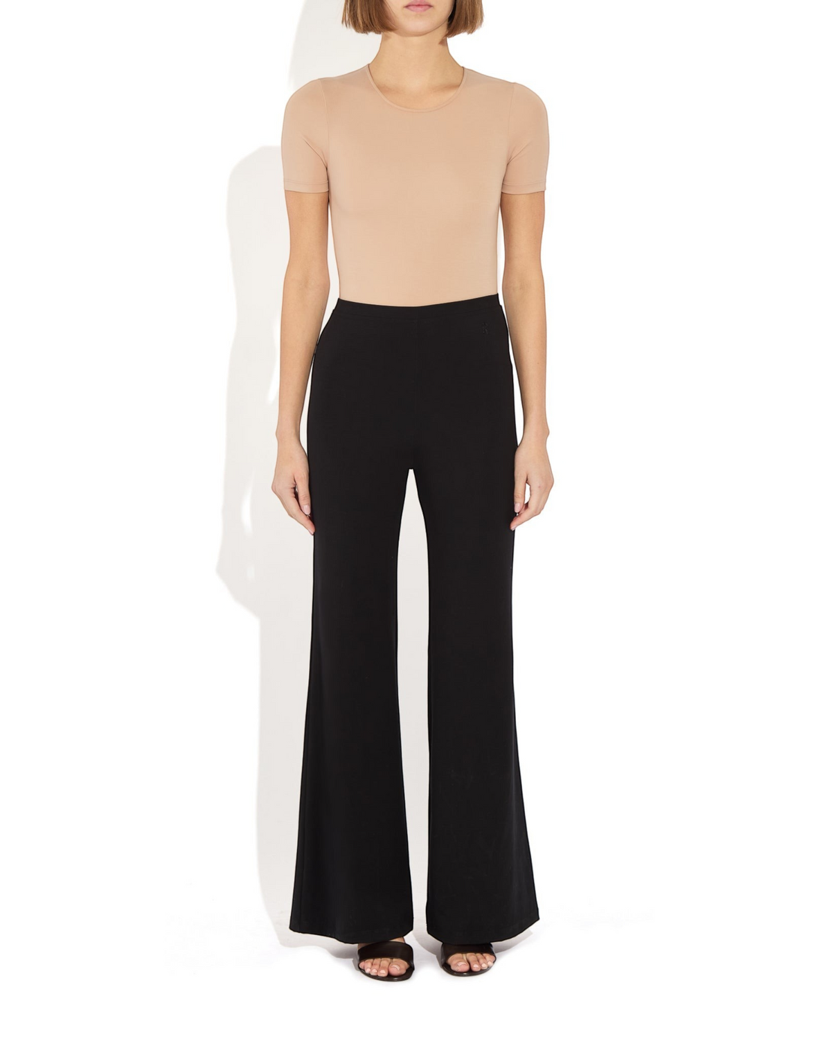 Weldun Penny short-sleeve bodysuit in beige MicroTencel with a ballerina neckline worn with black flared trousers