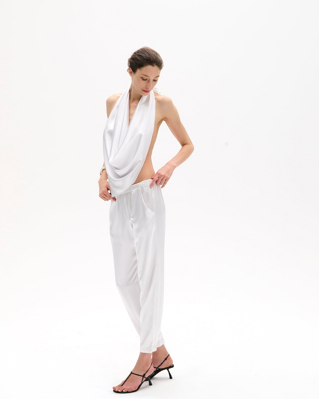 Weldun Rebecca Jogger in white mulberry silk with a tapered leg, elastic waistband, and side pockets on a model.