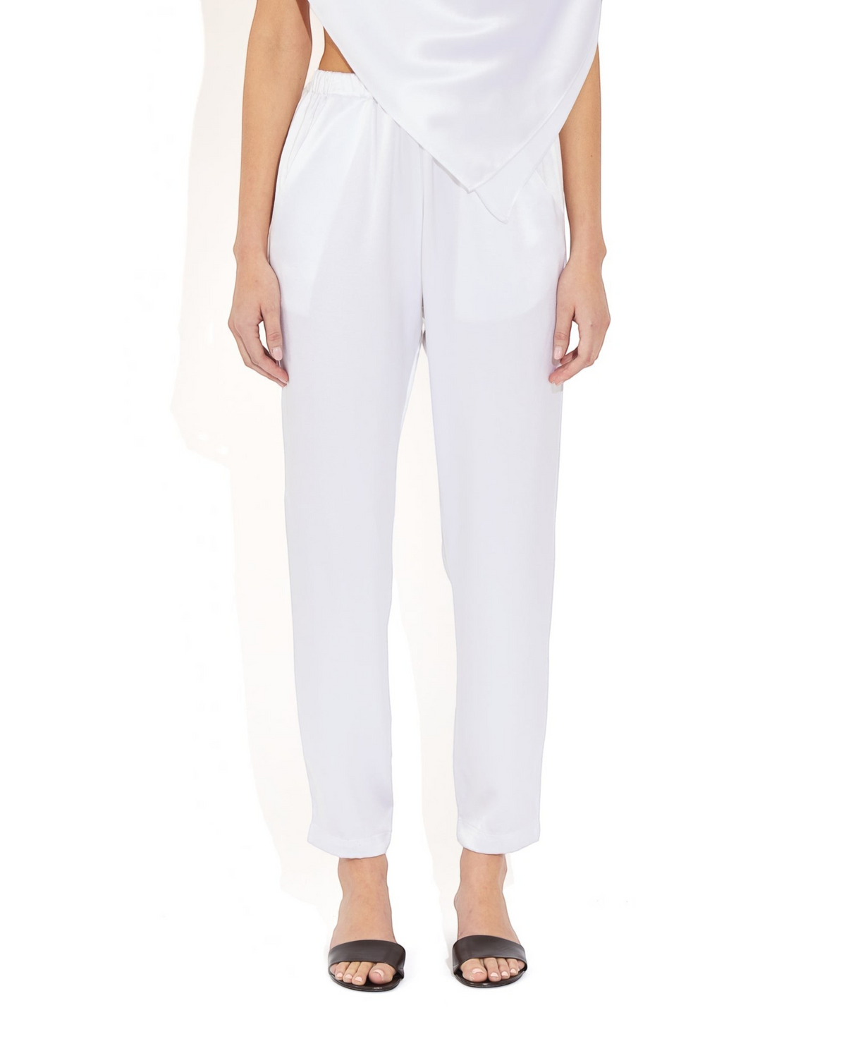 Weldun Rebecca Jogger in white mulberry silk with a tapered leg, elastic waistband, and side pockets on a model.