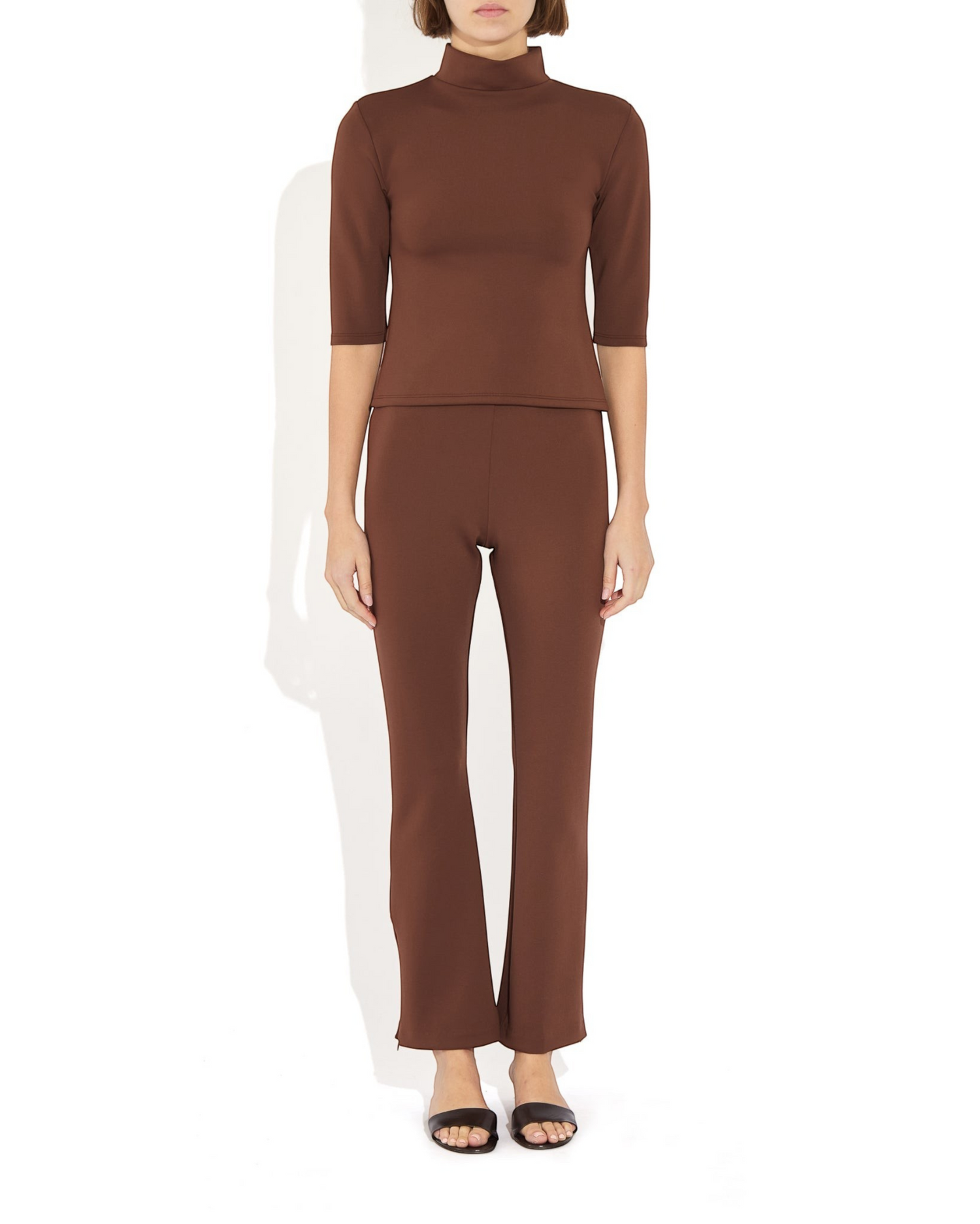 Weldun Sarah Pant in brown recycled polyester with elastic waistband and side hem zippers on a model