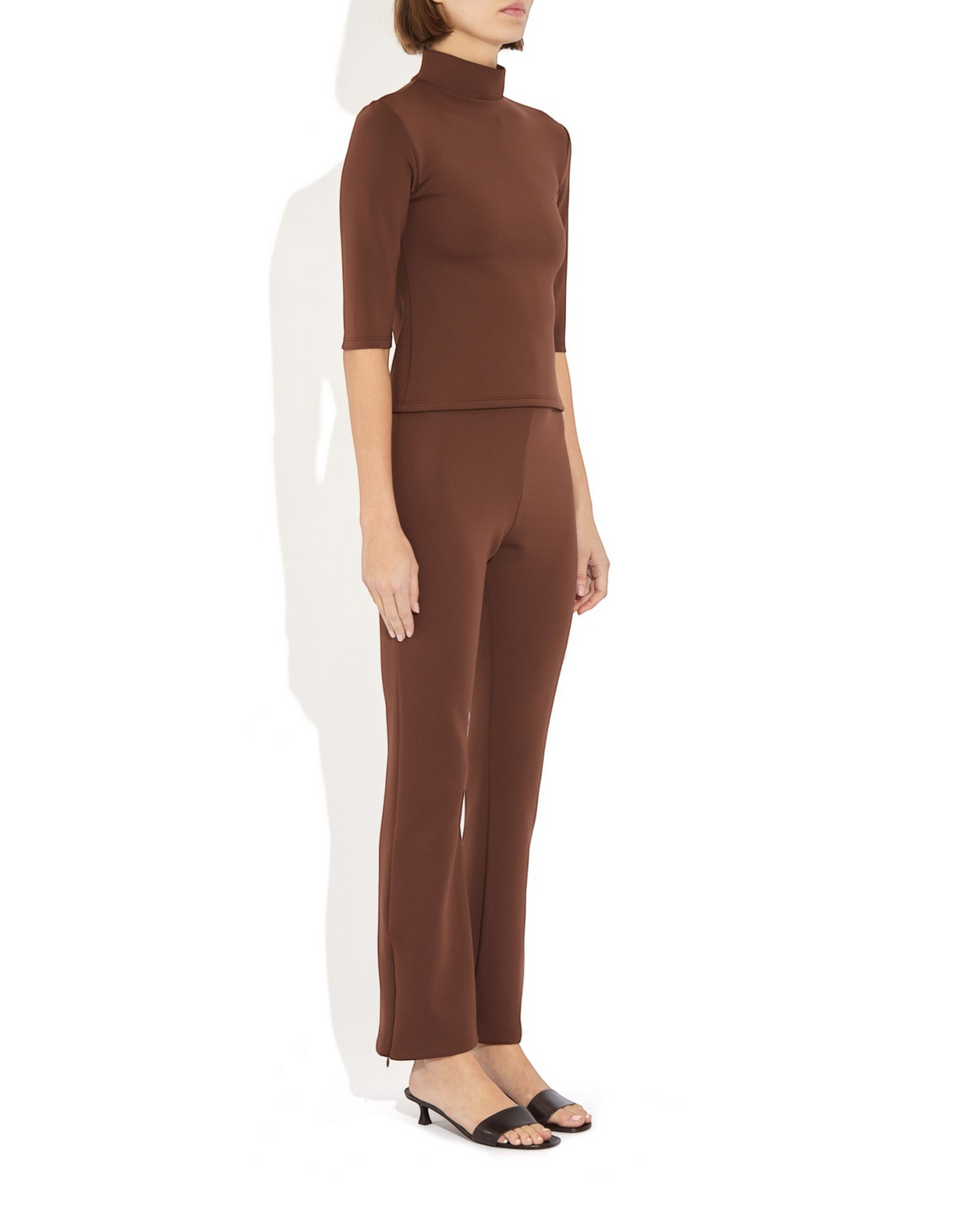 Weldun Sarah Pant in brown recycled polyester with elastic waistband and side hem zippers on a model
