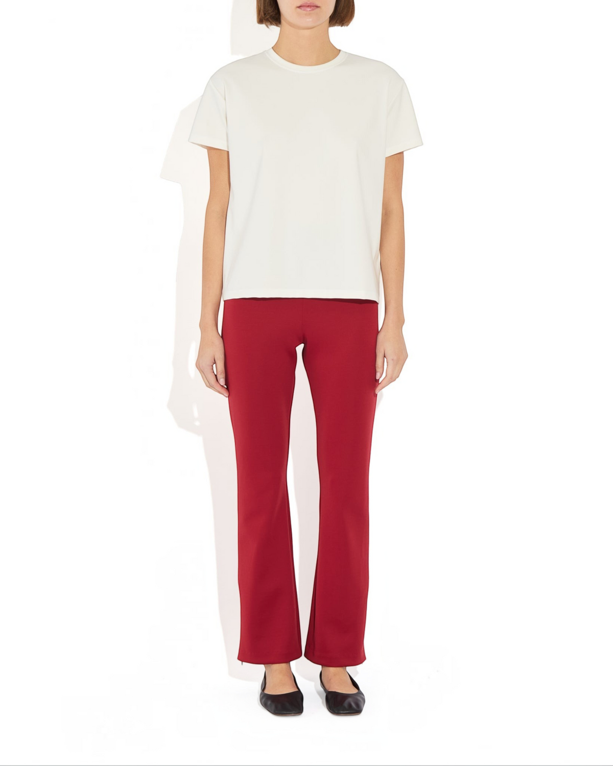 Weldun Sarah Pant in deep red, featuring a pull-on elastic waistband and adjustable side-zip hems on a model.