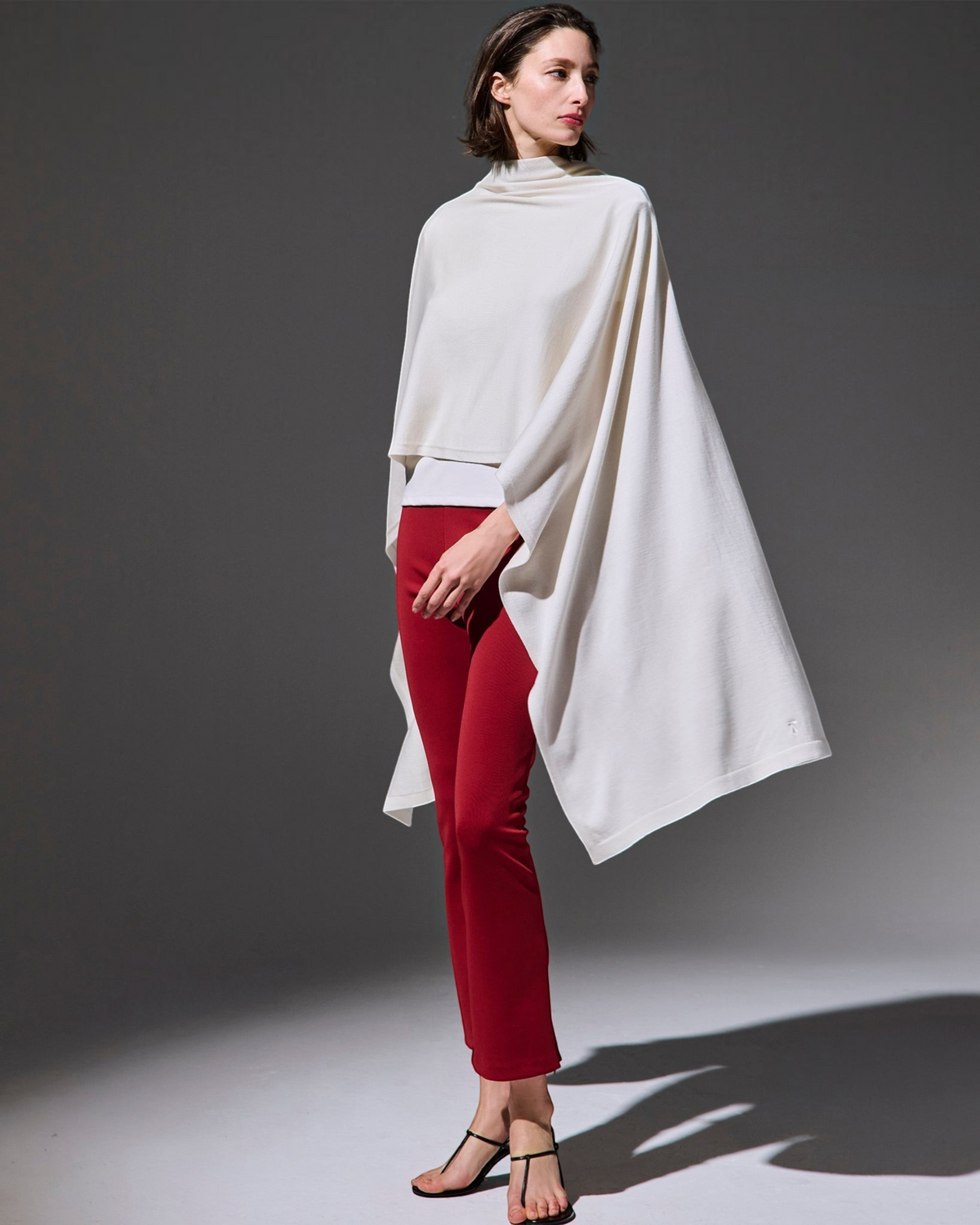 Weldun Sarah Pant in red, featuring a pull-on elastic waistband and side hem zippers, worn by a model in a studio.