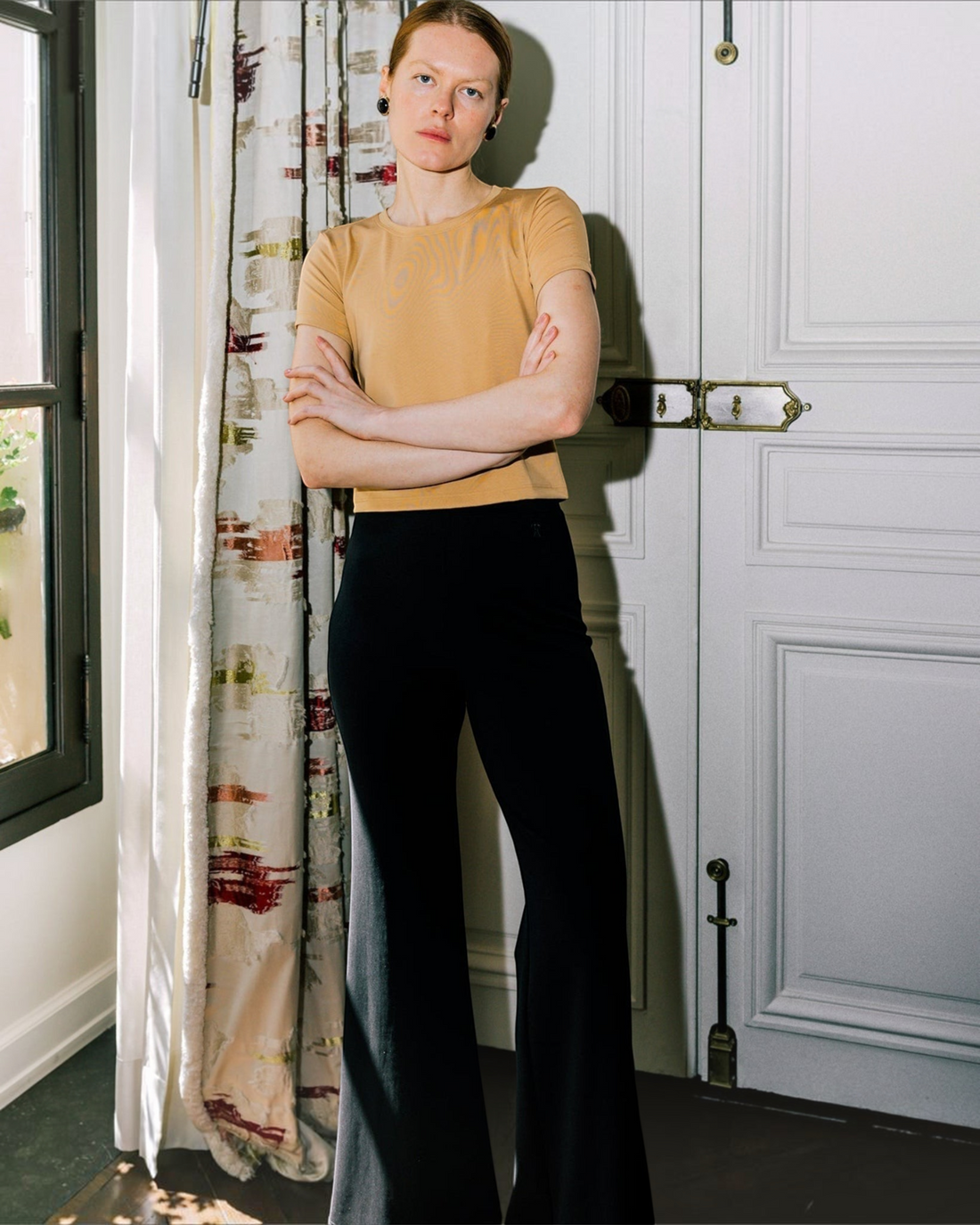 Weldun Tessa Long Pant in black, featuring a high elasticated waist and fluid flare leg in soft, breathable fabric.