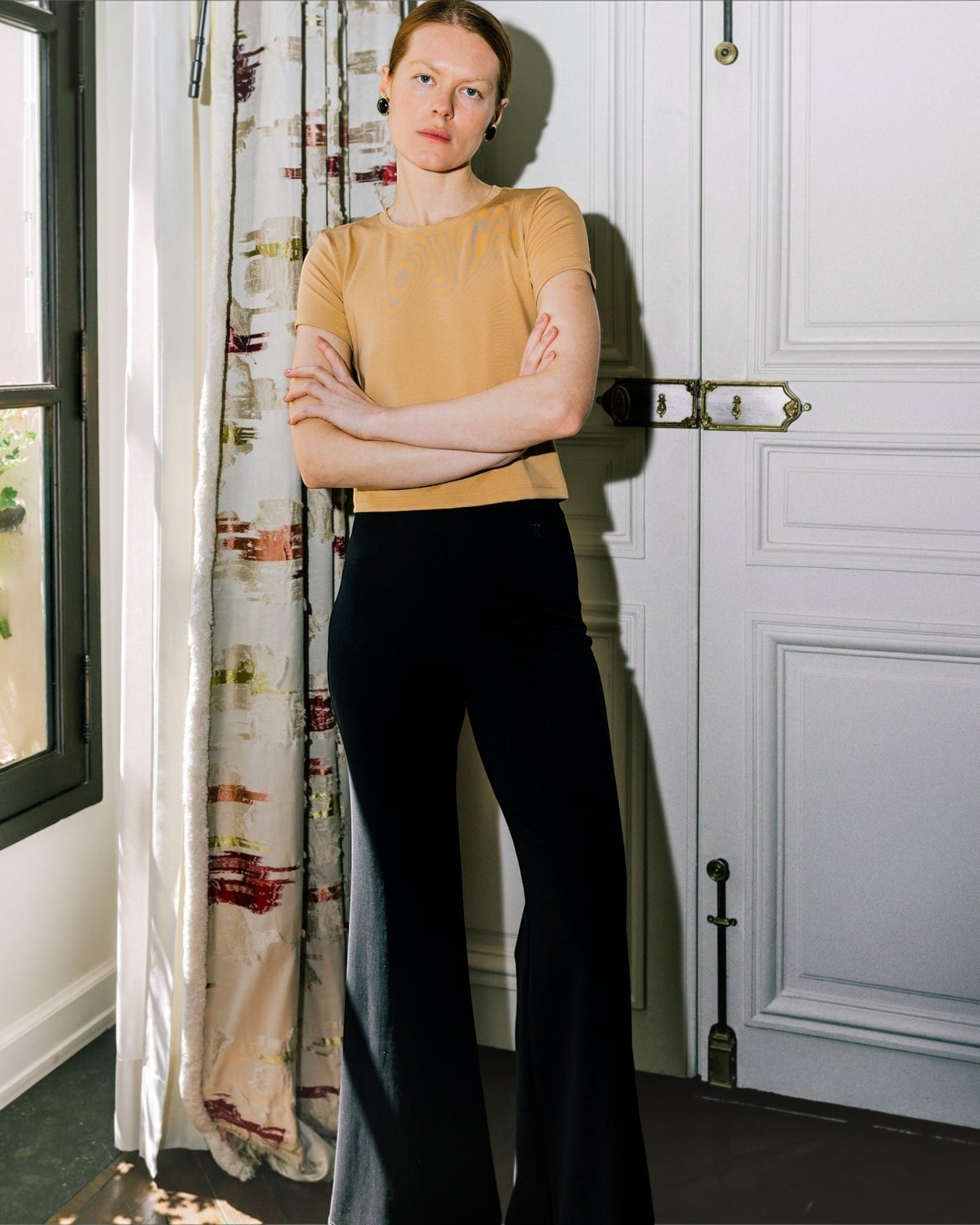 Weldun Tessa Long Pant in black, featuring a high elasticated waist and fluid flare leg in soft, breathable fabric.