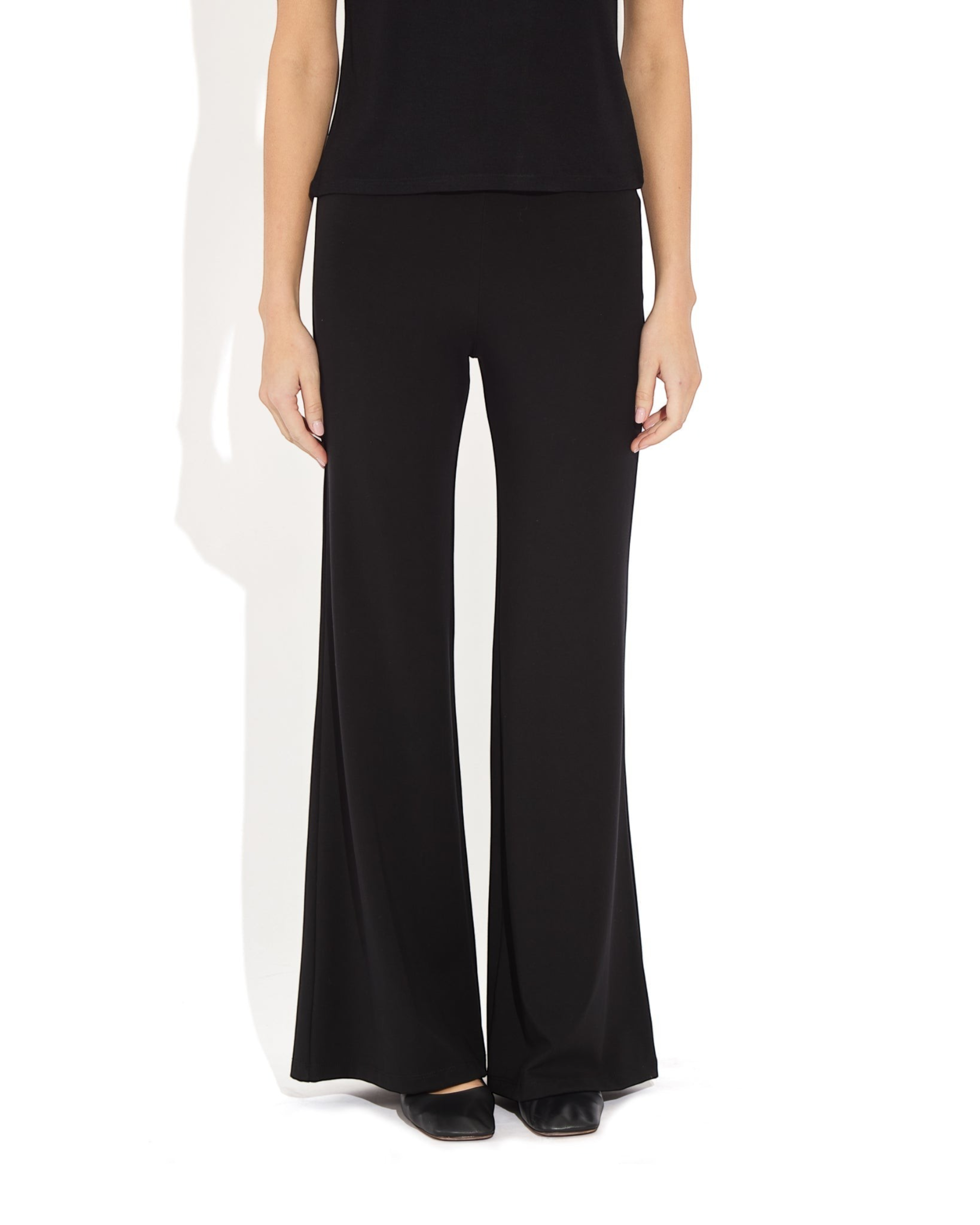 Weldun Tessa Long Pant in black featuring a high elasticated waist and fluid flare leg in soft breathable PYRATEX