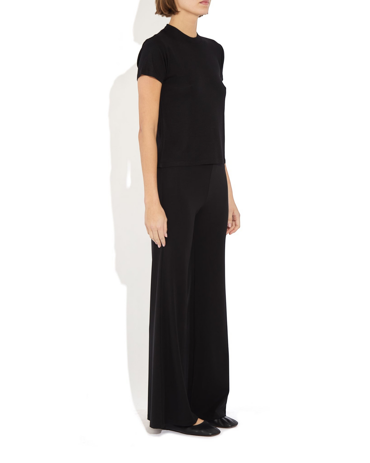 Weldun Tessa Long Pant in black, featuring a high elasticated waist and fluid flare leg in soft breathable fabric.
