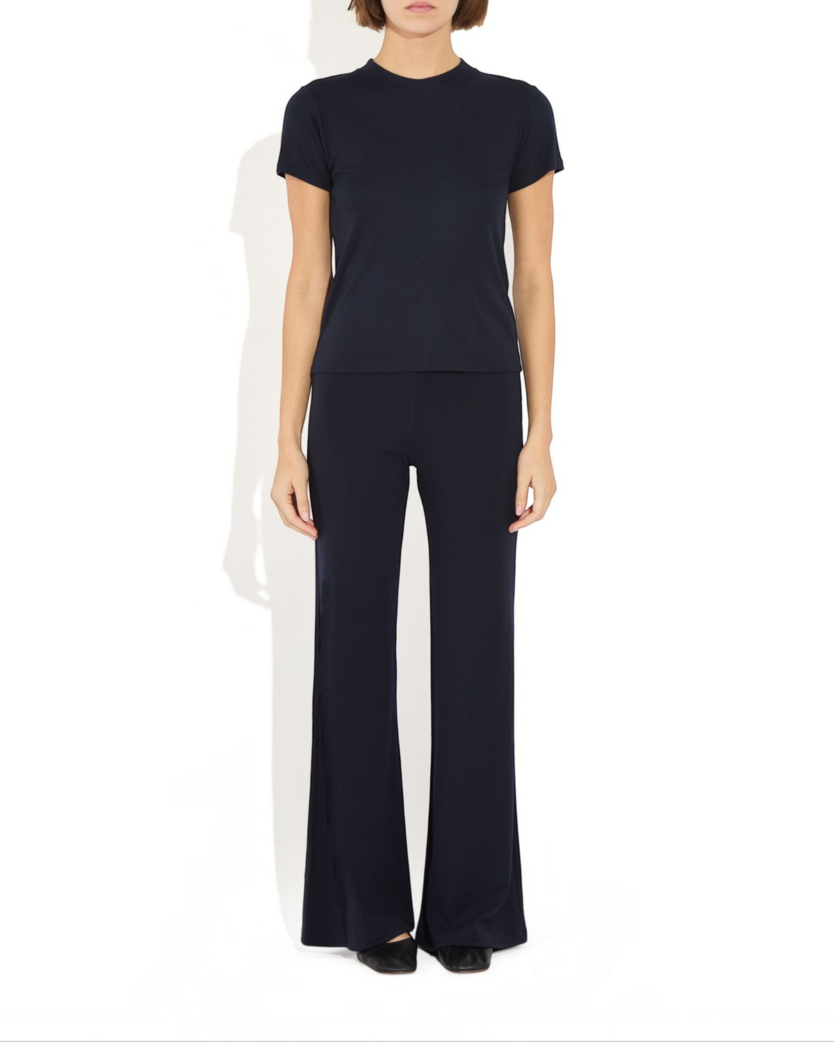 Weldun Tessa Long Pant in black, featuring a high elasticated waist and fluid flare leg in soft breathable fabric.