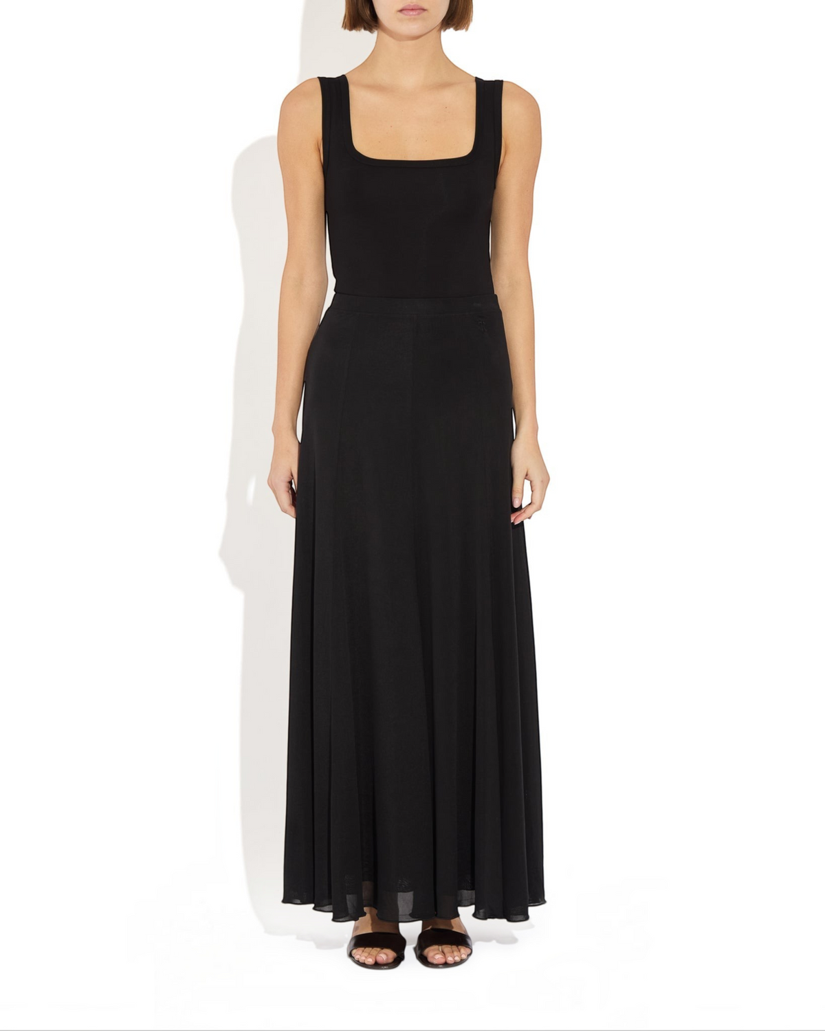 Weldun black semi-sheer Olivia maxi skirt in soft lyocell with a fluid paneled design and comfortable elastic waist.