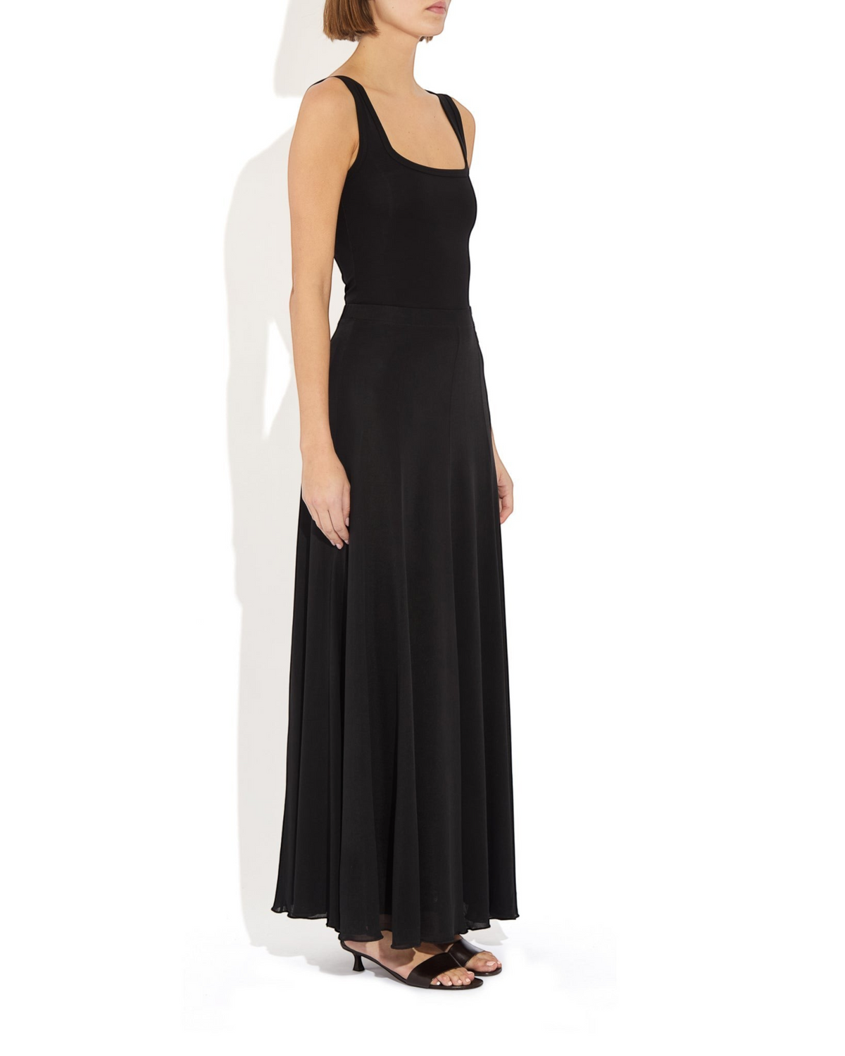 Weldun Semi-Sheer Olivia maxi skirt in black lyocell with an elastic waistband and fluid paneled construction.