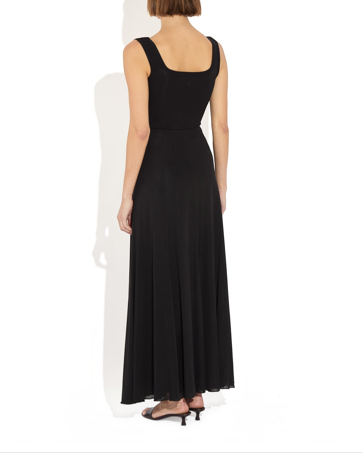 Weldun Olivia semi-sheer black maxi skirt with elastic waistband and fluid paneled construction on a model