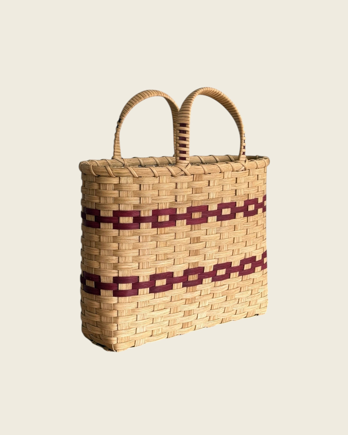 Weldun New England woven rattan shopping basket with natural and deep red geometric patterns and dual top handles.